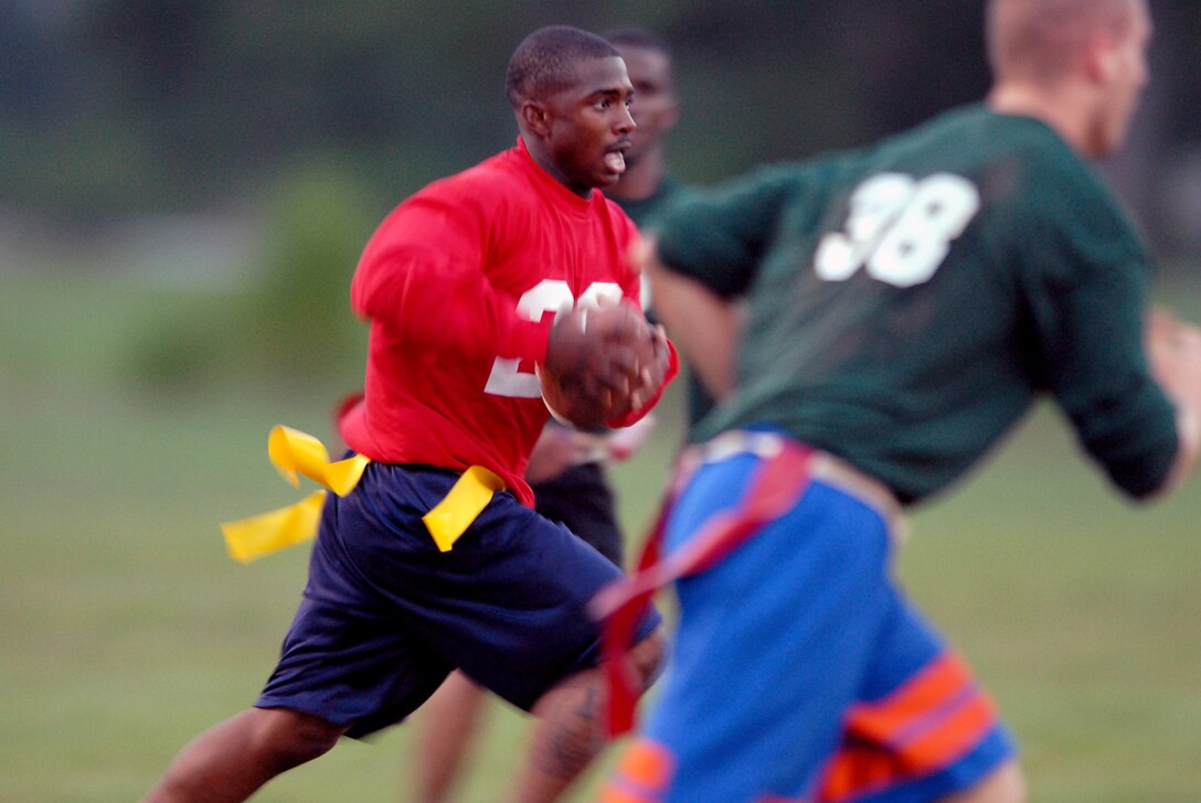 MARINE CORPS BASE CAMP LEJEUNE, N.C. -- Lance Cpl. Marshawm Shelling with 8th Communications Battalion runs the ball down field during their game against 2nd Tank Battalion here Sept. 11. Communications Battalion beat Tank Battalion 13-12 in one of the first games of the 2006 Intramural Flag Football League.