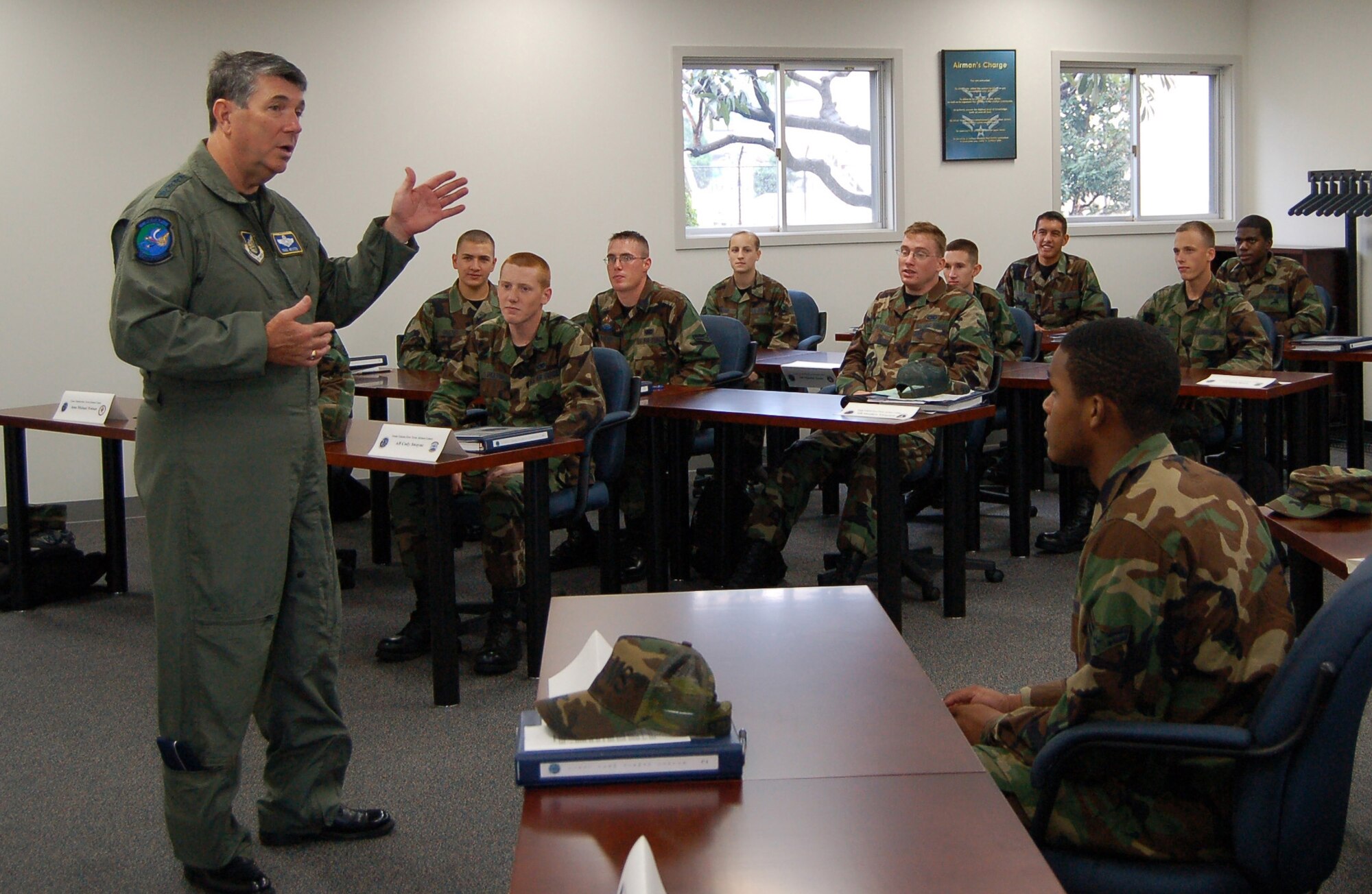 Gen. Paul V. Hester talks to First Term Airman Center students at the new Professional Military Education center. The PME center will give new Airmen a world class facility to work out of that is now co-located with the Airman Leadership School. General Hester thanked Airmen for the voluntary service and asked them to take the most out of the education they are being provided to lead future Airmen in their units.