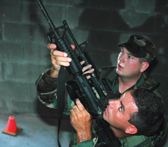 Tech. Sgts. Tim Morton (front) and Christopher Hill, 919th Security Forces Squadron, practice clearing a stairwell before advancing Aug. 5 during Military Operations in Urban Terrain Training on Eglin Air Force Base. The training prepares Airmen for clearing pathways and hostage rescue missions.