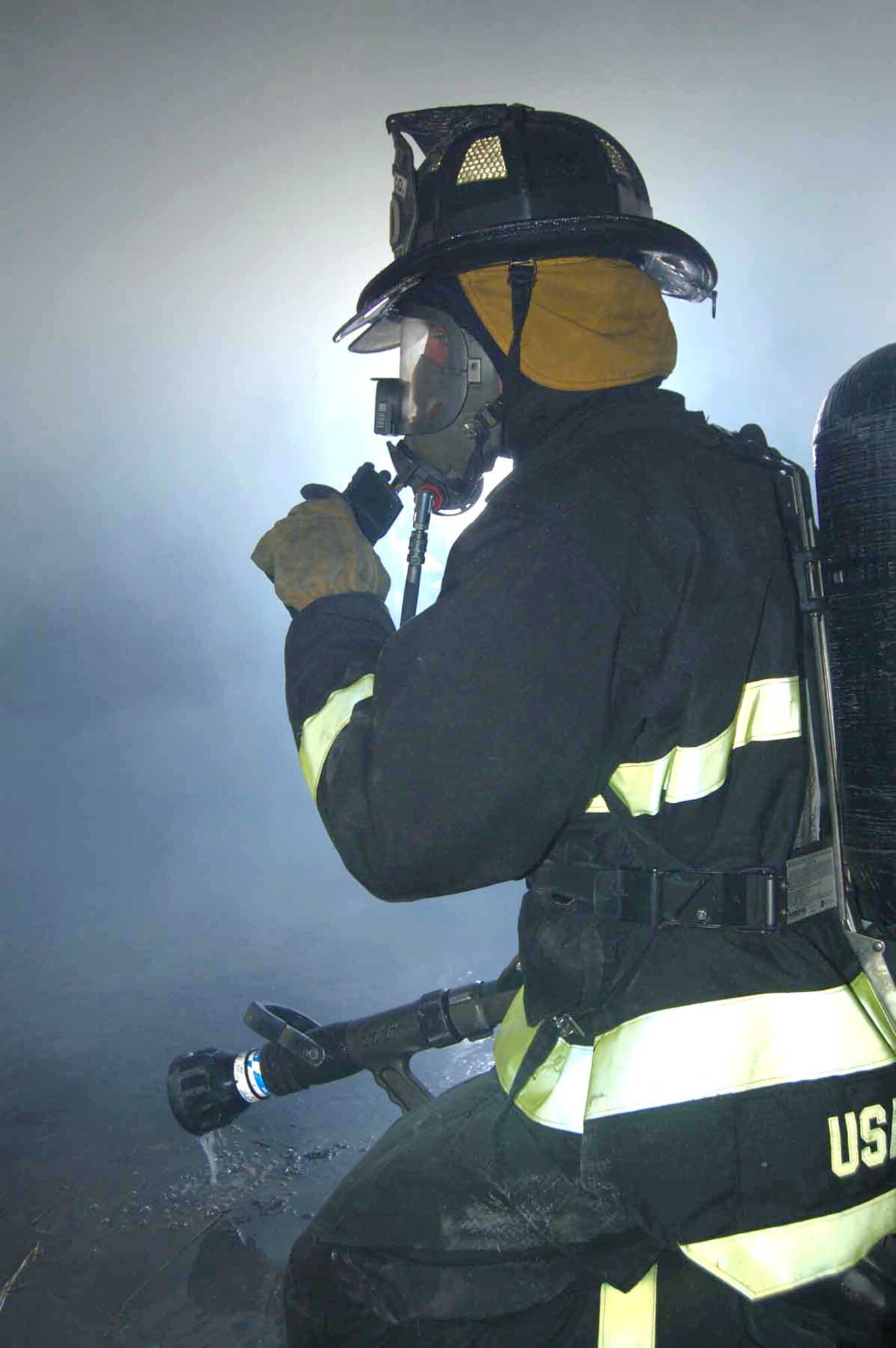 Staff Sgt. Jack Snyder communicates to safety observers during a live-fire training exercise at Spangdahlem Air Base, Germany, Sept. 10. Sergeant Snyder is a firefighter assigned to the 52nd Civil Engineer Squadron. (U.S. Air Force photo/Staff Sgt. Tammie Moore)
