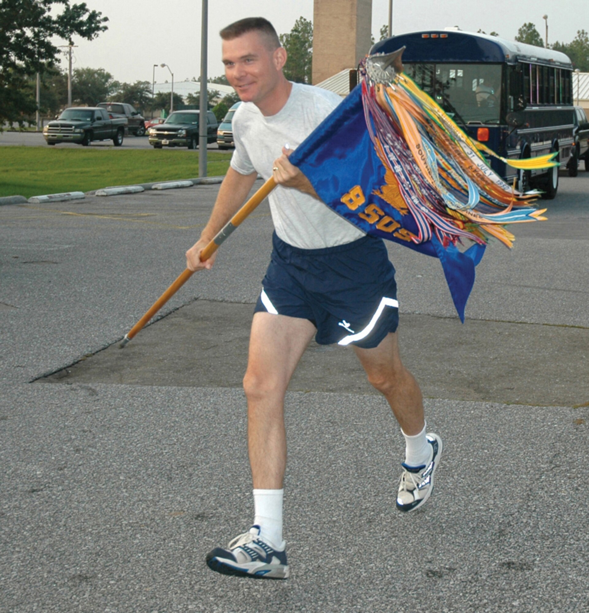 Lt. Col Paul Caltagirone, 8th Special Operations Squadron director of operations, takes his squadron guidon on its first leg of the return journey to its new home at Hurlburt Field Aug. 9. Squadron members took turns carrying the guidon through the 26-mile stretch.
