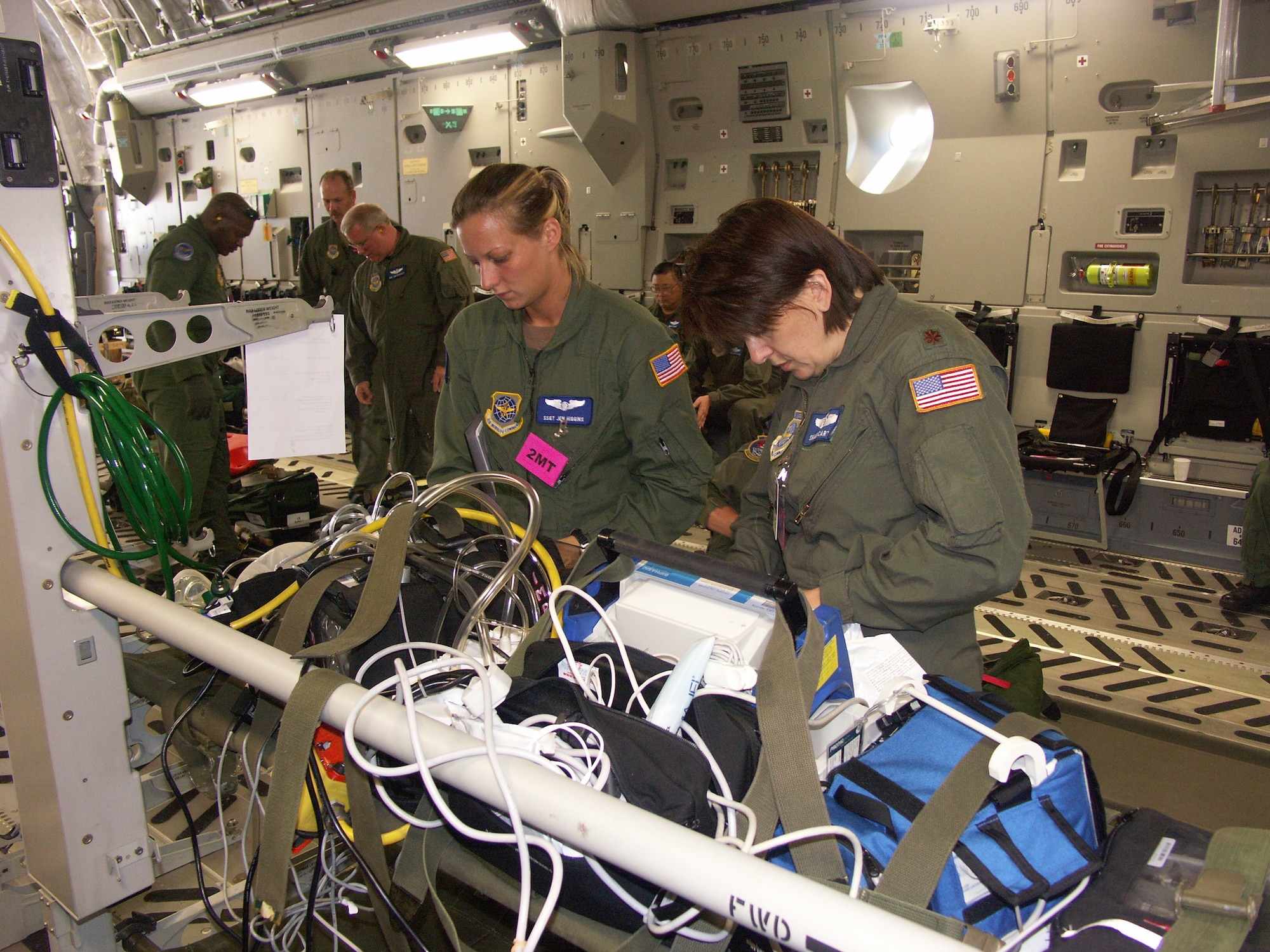 Two 932nd Aeromedical Evacuation Squadron members, Staff Sgt. Jennifer Higgins (left) and Maj. Shaun Carter, prepare their medical equipment before a training flight on board a visiting C-17 Globemaster from March Air Reserve Base, Calif.  Photo/Tech. Sgt. Gerald Sonnenberg