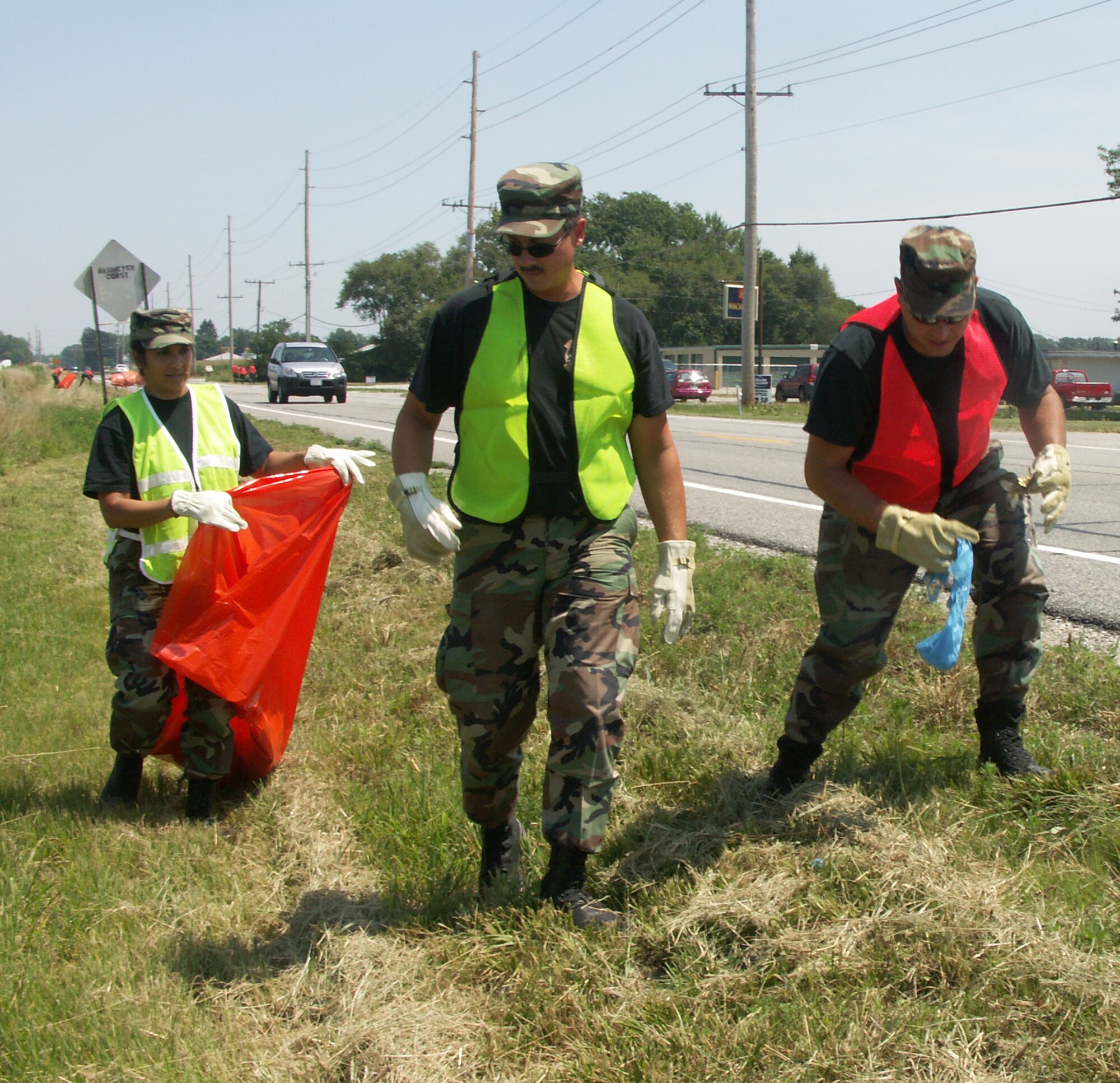 A dozen members of the 932nd Airlift Wings' Rising Six, Top Three and Chiefs' Group organizations braved the heat and humidity to help clean up a mile-long section of  IL highway 161.  The group met in the middle, then split  into four teams covering both sides of the stretch in about 90 minutes.  Photo/Tech. Sgt. Gerald Sonnenberg