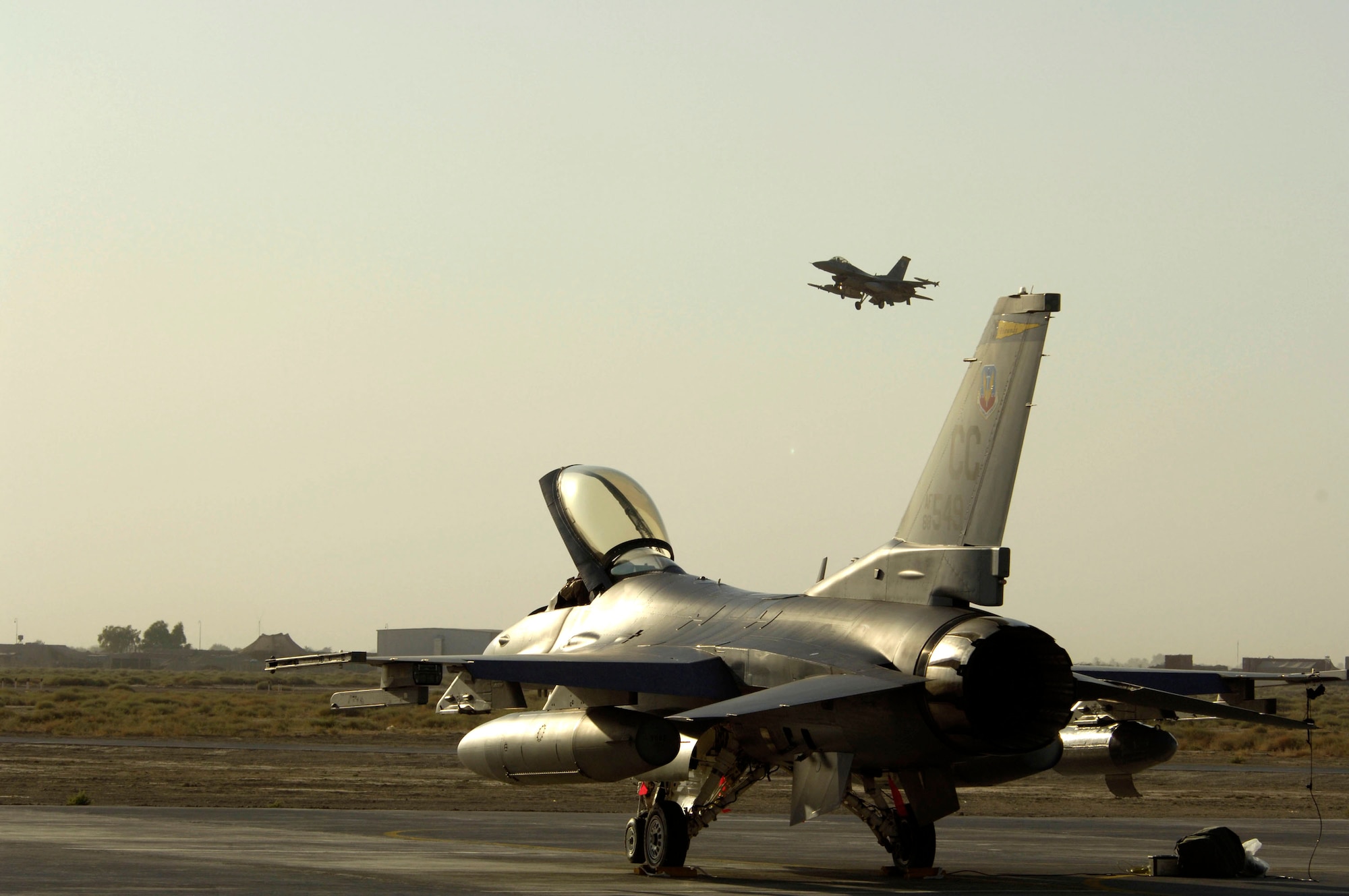 One F-16 Fighting Falcon taxis while another takes off from Balad Air Base, Iraq, Sept. 9. The F-16s, from Cannon Air Force Base, N.M., just arrived to support Operation Iraqi Freedom. (U.S. Air Force photo/Airman 1st Class Chad M. Kellum) 
