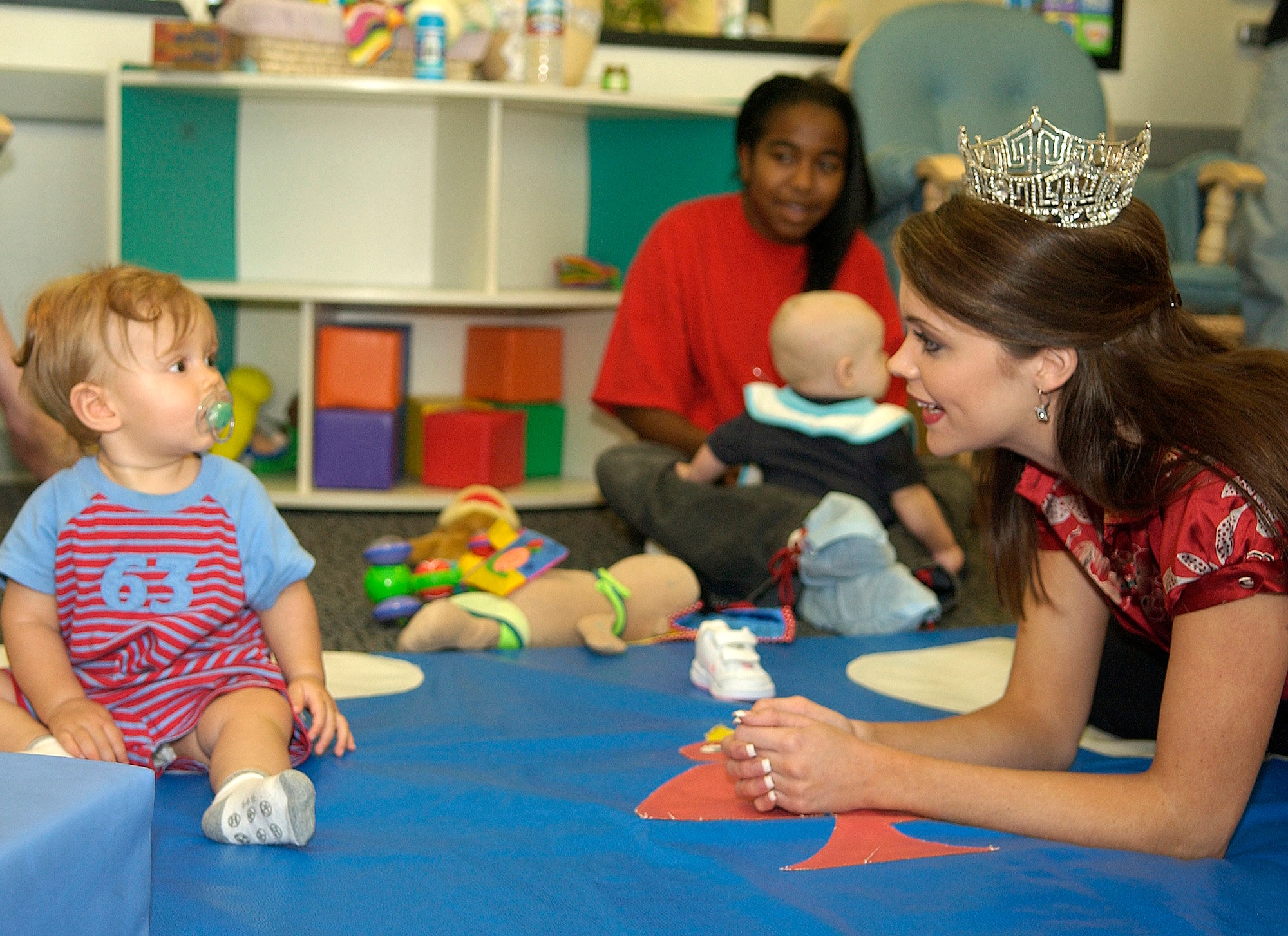 Miss America Jennifer Berry plays with a child at the child development center at Los Angeles Air Force Base, Calif., during her tour of the base Sept. 12. (U.S. Air Force photo/Stephen Schester) 
