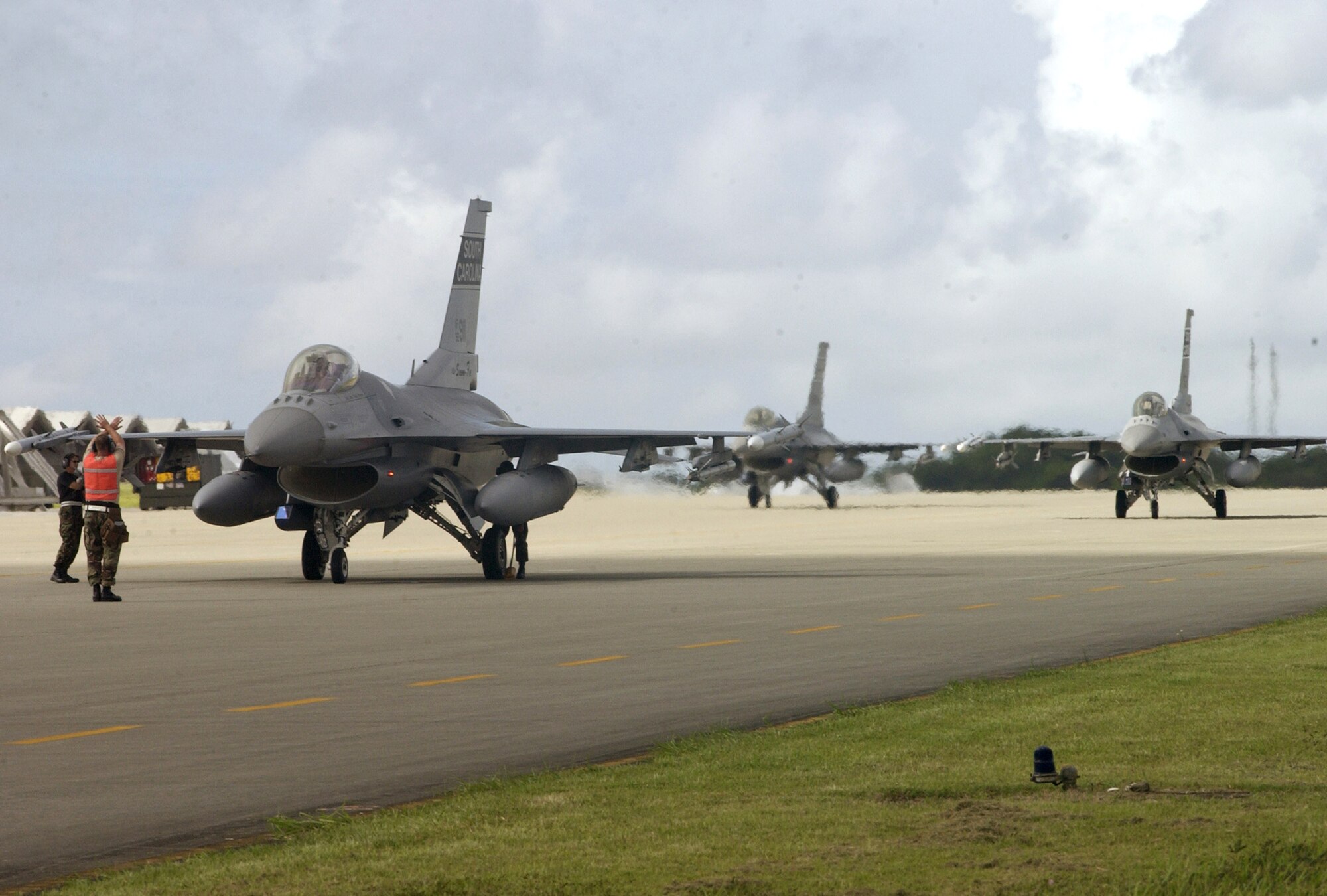 F-16 Fighting Falcons assigned to the South Carolina Air National Guard's 157th Fighter Squadron taxi in at Kadena Air Base, Japan, after a mission Sept. 11. Twelve aircraft and more than 300 Airmen from the South Carolina Air National Guard's 157th Fighter Squadron are deployed to Kadena to conduct theater orientation training. (U.S. Air Force photo/Master Sgt. Marvin R. Preston) 