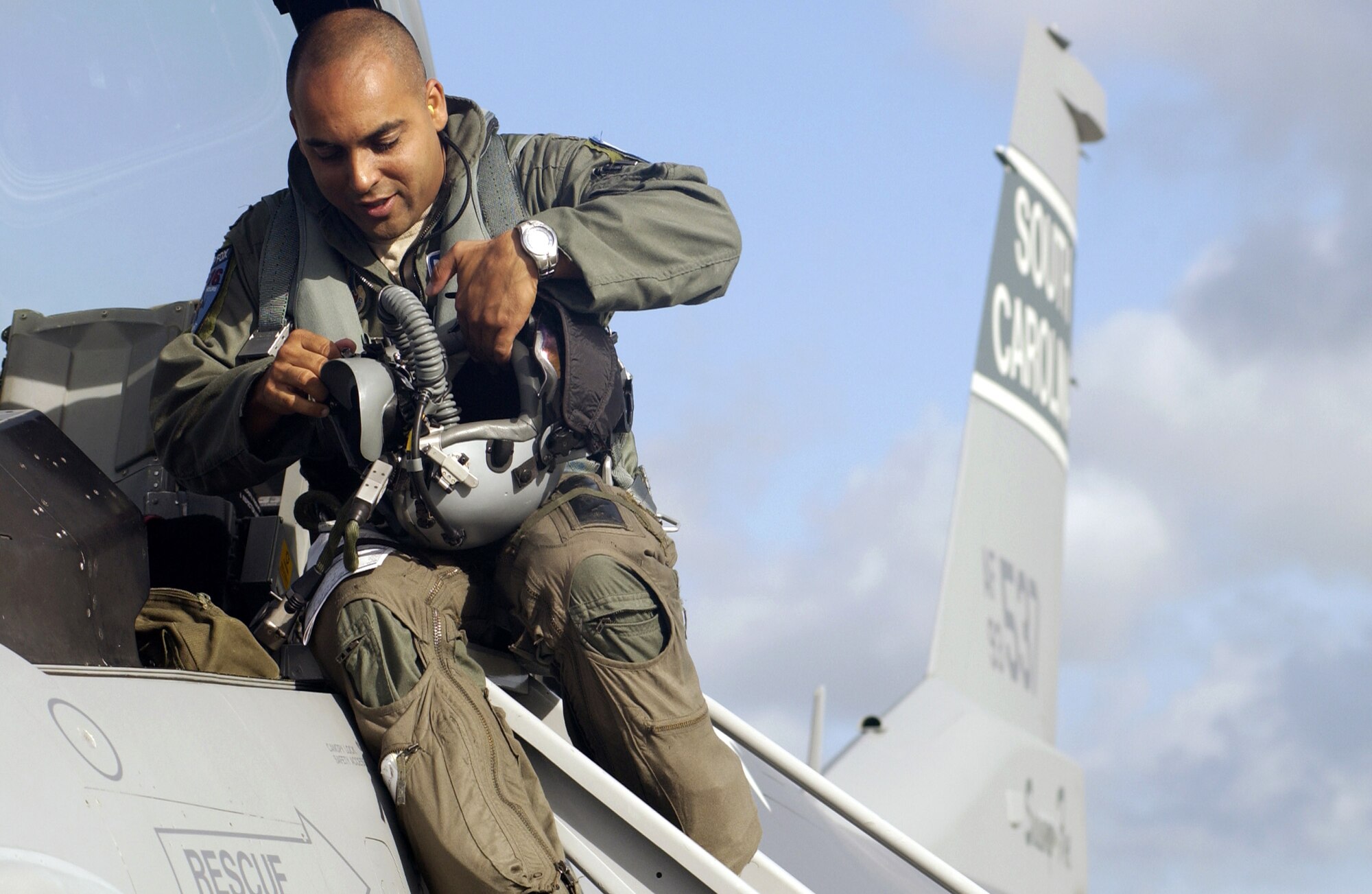 Maj. Abu Ghandi checks his helmet before takeoff at Kadena Air Base, Japan, Sept. 11. Twelve aircraft and more than 300 Airmen from the South Carolina Air National Guard's 157th Fighter Squadron are deployed to Kadena to conduct theater orientation training. Major Ghandi is an F-16 Fighting Falcon pilot assigned to the 157th FS. (U.S. Air Force photo/Master Sgt. Marvin R. Preston)
