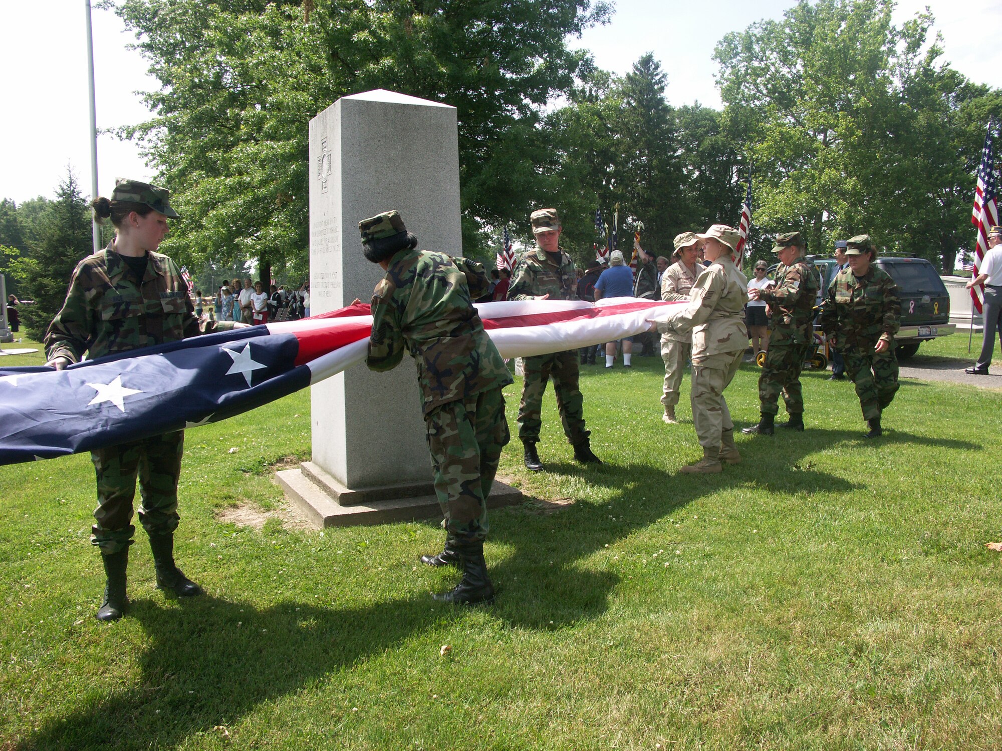 Members of the 932nd Airlift Wing fold the unit's American flag after carrying it in the Belleville, Ill., Memorial Day parade. Reservists of the unit participated in the event which ended at Walnut Hill Cemetery next to monuments honoring America's  war dead.   The next parade is Veteran's Day. 