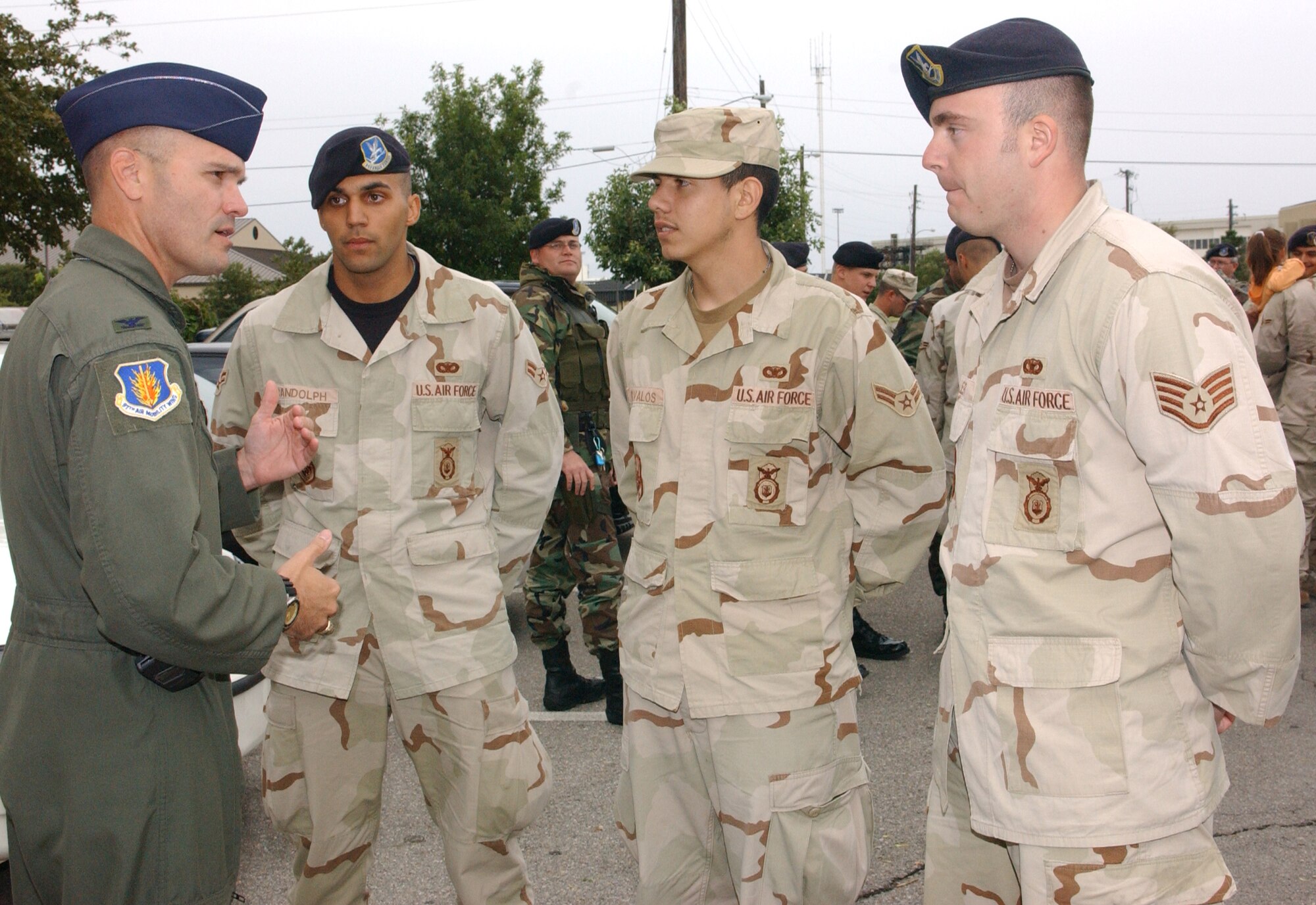ALTUS AIR FORCE BASE, Okla. (AETCNS) -- Col. Carlton D. Everhart II, 97th Air Mobility Wing commander, welcomes home three members of the 97th Security Forces Squadron arriving here Oct. 6 from a deployment. Airman 1st Class David Randolph, Airman 1st Class Hector Davalos and Staff Sgt. John Miller received Purple Hearts after surviving an explosion when their vehicle detonated a hidden land mine in Mosul, Iraq, on June 22. (U.S. Air Force photo by Staff Sgt. Kristi Machado)