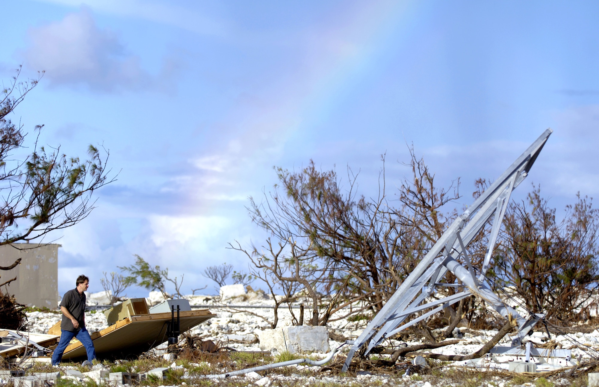 A Defense Department employee surveys some of the damage left on Wake Island by Super Typhoon Ioke after it hit the island Aug. 31. A C-17 Globemaster III from Hickam Air Force Base, Hawaii, brought a 53-person team to assess damage left by the typhoon. (U.S. Air Force photo/Tech. Sgt. Shane A. Cuomo) 
