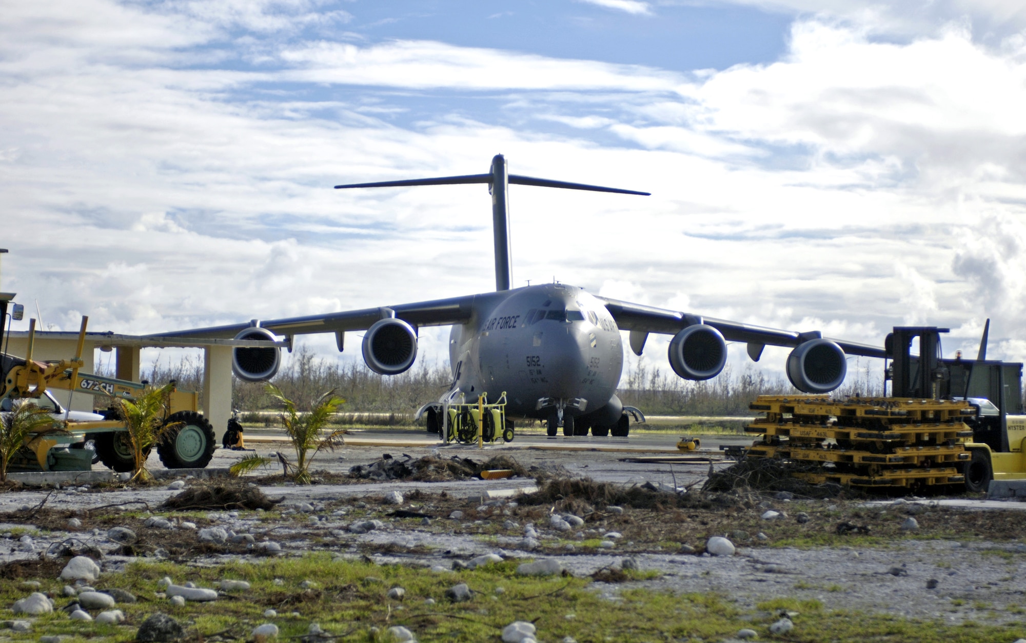 A C-17 Globemaster III sits on the flightline at Wake Island Sept. 12. Debris and coral are signs of the destruction left by Super Typhoon Ioke after it hit the island Aug. 31. The C-17 Globemaster III is from Hickam Air Force Base, Hawaii, and brought a 53-person team to the island to assess damage left by the typhoon. (U.S. Air Force photo/Tech. Sgt. Shane A. Cuomo) 

