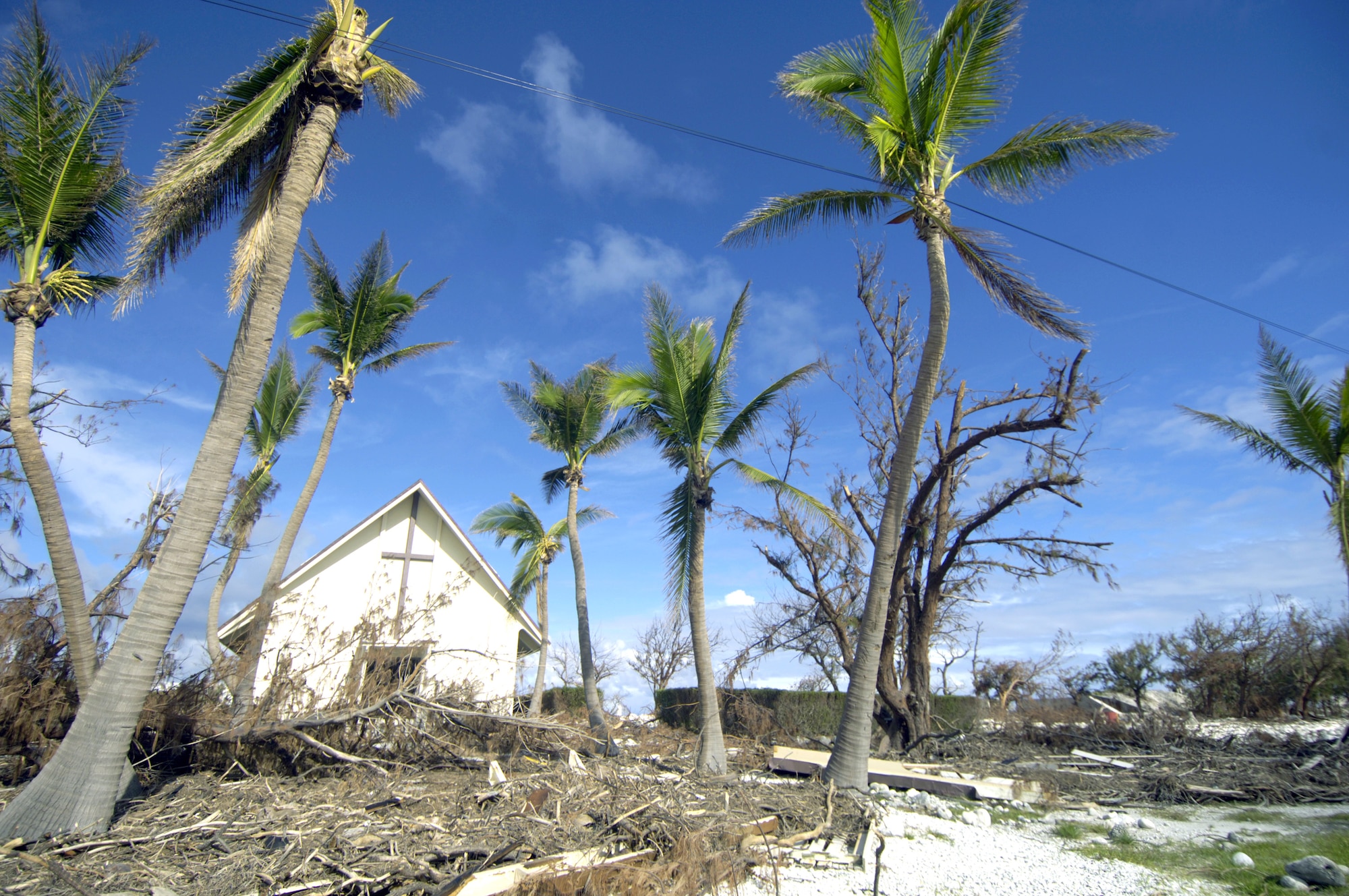 A damaged church, dead trees and debris on Wake Island are signs of the destruction left by Super Typhoon Ioke when it hit the island Aug. 31. A C-17 Globemaster III from Hickam Air Force Base, Hawaii, brought a 53-person team to the island Sept. 12 to assess damage left by the typhoon. (U.S. Air Force photo/Tech. Sgt. Shane A. Cuomo) 