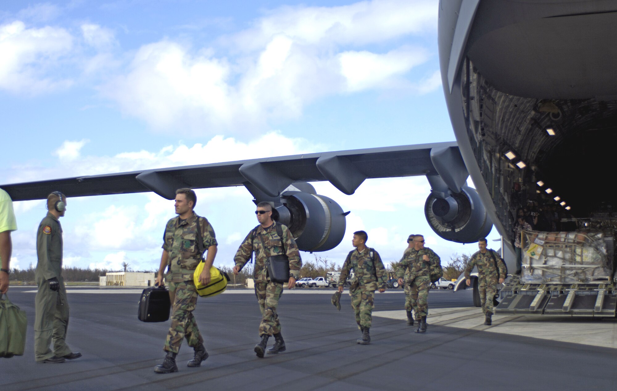Airmen, part of a 53-person assessment team, get off a C-17 Globemaster III at Wake Island Sept. 12. The team is assessing damage left by Super Typhoon Ioke after it struck the island Aug. 31. (U.S. Air Force photo/Tech. Sgt. Shane A. Cuomo) 