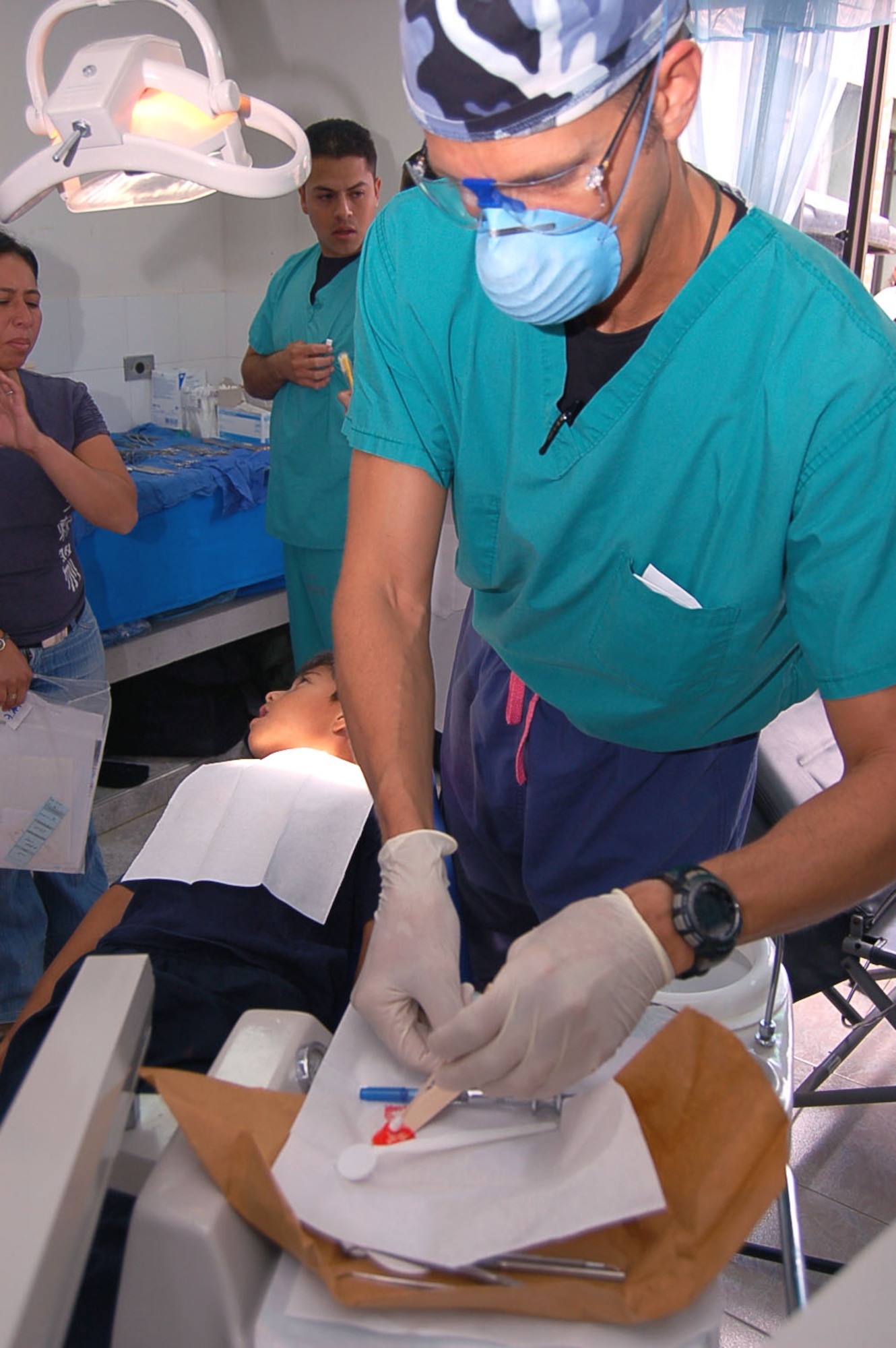 Lt. Col. (Dr.) Gary Geracci prepares to remove a decayed tooth from the mouth of a Colombian boy at the Hospital Toribo Maya in Popayan, Colombia, Sept. 12. The colonel is one of 14 members of a medical team sent to Colombia to participate in a medical readiness training exercise. He is an oral surgeon assigned to the 55th Medical Group at Offutt Air Force Base, Neb. (U.S. Air Force photo/Staff Sgt. Matthew Bates)