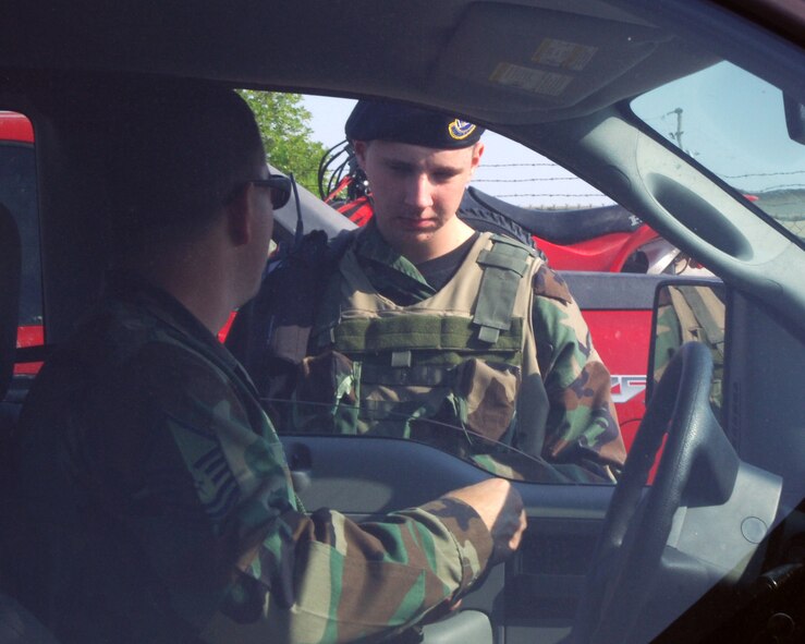 Minot Air Force Base, N.D. -- Airman Eric Syriac, 5th Security Forces Squadron, checks identification cards to ensure only authorized personnel are allowed entry to the base Sept. 11. Checking IDs is a part of support of Antiterrorism during Exercise Prairie Defense.  (U.S. Air Force photo by Airman First Class Joe Rivera) 