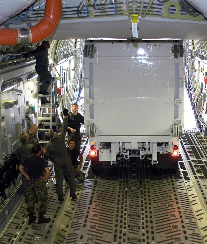 Airmen monitor the 4th Space Operations Squadron's Ground Mobile-3 vehicle as it backs into a C-17 Globemaster III cargo bay at Peterson Air Force Base, Colo., Sept. 10. Deploying the GM-3 on a C-17 instead of a C-5 Galaxy will save the Air Force more than $360,000 per flight. (U.S. Air Force photo/Staff Sgt. Don Branum) 