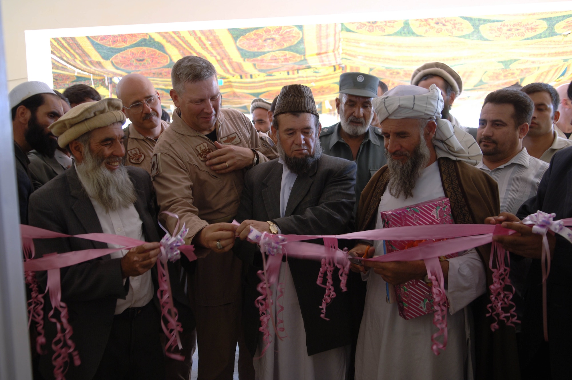 Brig. Gen. Christopher Miller, 455 AEW commander, assists in the ribbon-cutting ceremony celebrating the opening of a new school near Bagram airfield.  The school project was spearheaded by the PRT, or Provincial Reconstruction Team, which overseas several construction projects such as roads and wells all over Afghanistan. (US Air Force photo/Tech. Sgt. Joseph Kapinos)