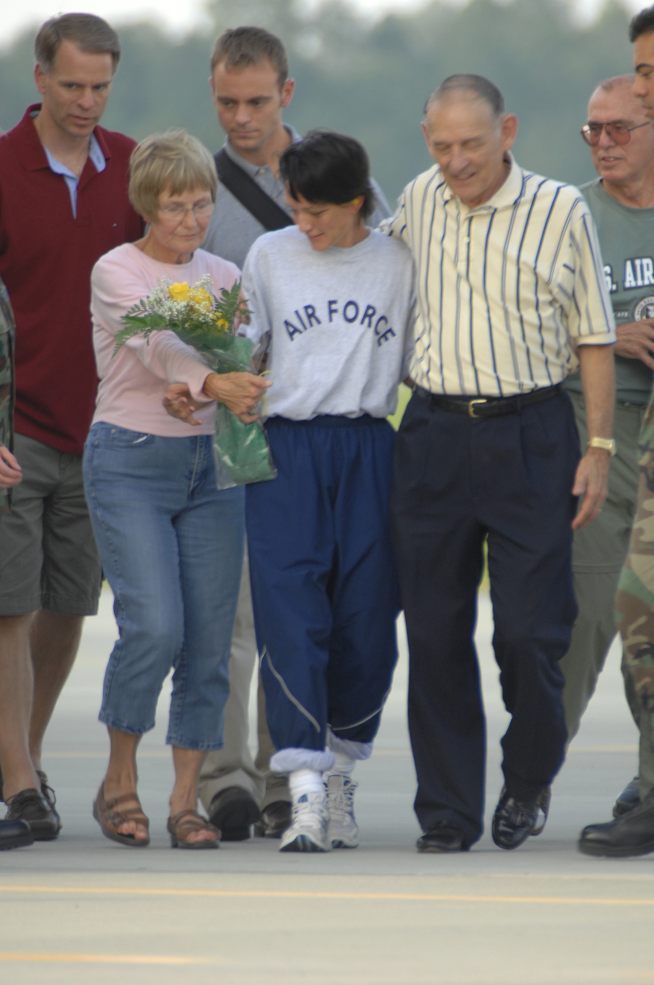 Maj. Jill Metzger (center in Air Force shirt) talks with family members after arriving at Moody Air Force Base, Ga., Sept. 14.  Major Metzger, deployed to Manas Air Base, Kyrgystan, as part of an Air Expeditionary Task Force, was reported missing on Sept. 5.  Kyrgyz law enforcement officials found her Sept. 8.  Subsequently she was transported to Landstuhl Regional Medical Center near Ramstein Air Base, Germany, for debriefings and medical evaluations.  (U.S. Air Force photo/Senior Airman Joshua Jasper)