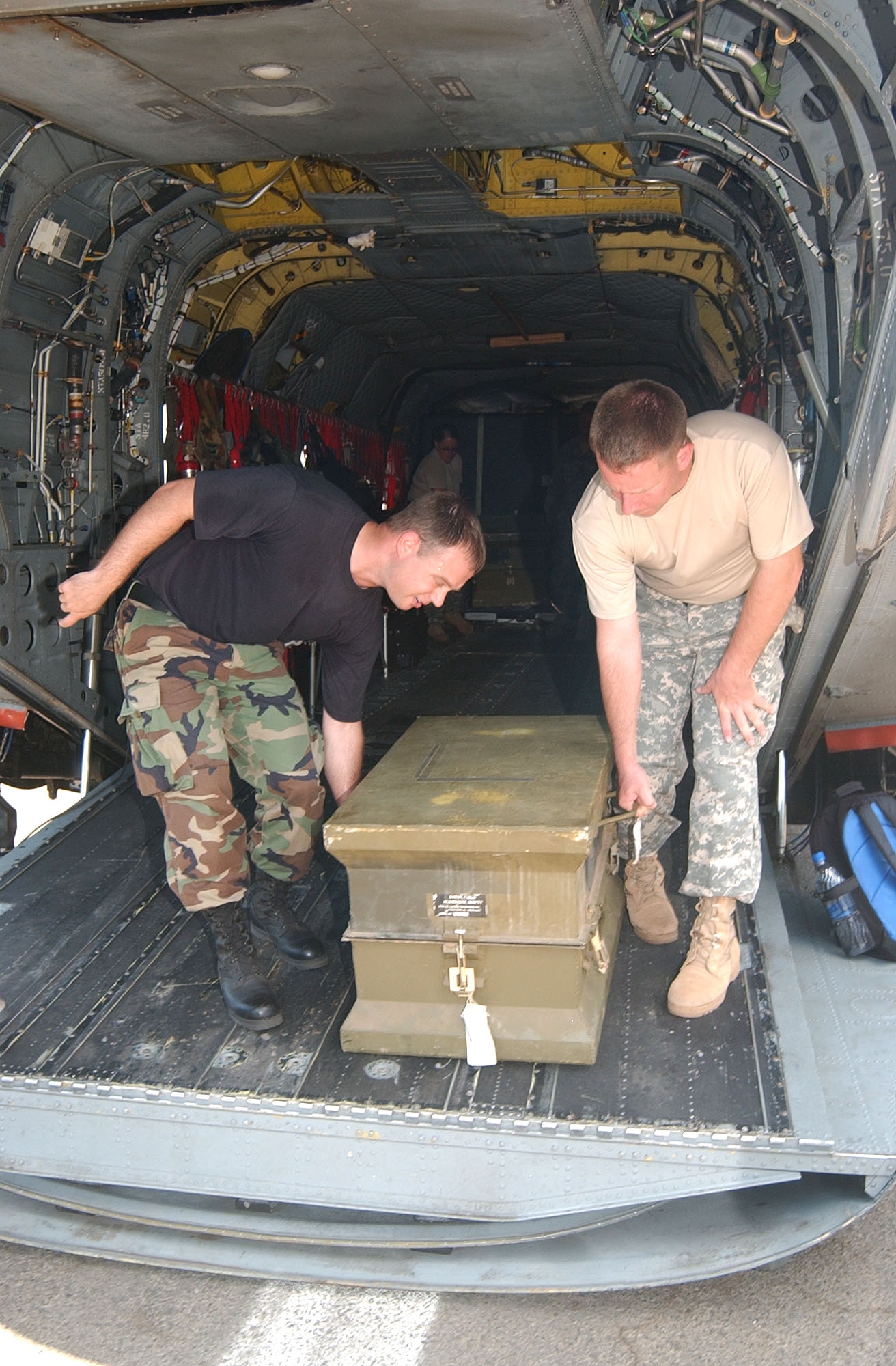 Staff Sgt. Robert Jessop and Army Staff Sgt. William Grieshaber unload a trunk filled with medical equipment which was donated to a hospital in Leon, Nicaragua, Sept. 13. Joint Task Force-Bravo members at Soto Cano Air Base, Honduras, donated more than $185,000 worth of medical equipment and supplies to a hospital in Leon where 45 people died and hundreds more were being treated for alcohol poisoning. (U.S. Air Force photo/Capt. Alysia Harvey) 
