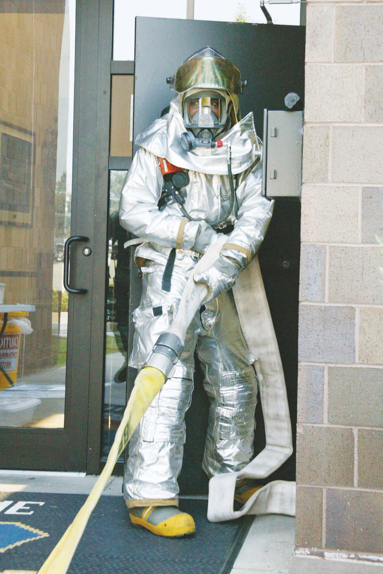 Senior Airman Edwin Gaines, 20th Civil Engineer Squadron fire fighter, prepares to extinguish a simulated fire Monday as part of the Phase II operational readiness exercise. (U.S. Air Force photo/Tarsha Storey)