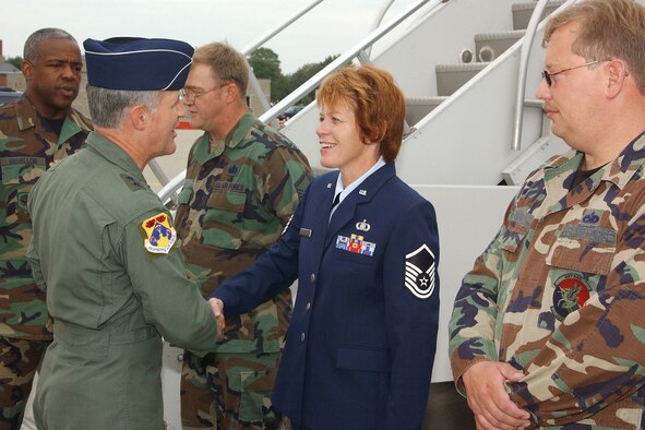 Maj. Gen. James A. Hawkins, commander 18AF, is greeted upon his arrival Aug 28 at Selfridge ANG Base, Mich., by Master Sgt. Teresa M. Beckett, 63rd Air Refueling Squadron, assigned to 927th Air Refueling Wing (Air Force Reserve) .