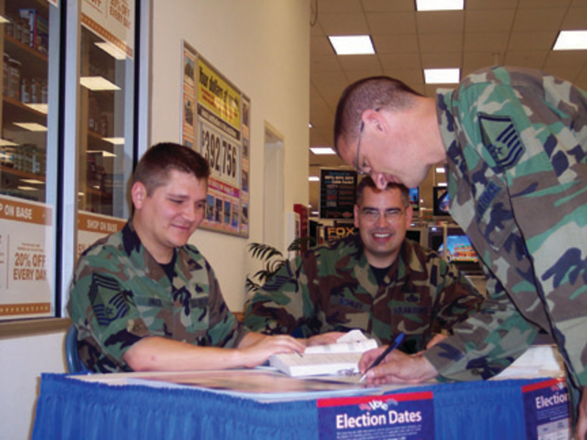Chief Master Sgt. William Urick and Master Sgt . Paul Schiley, both 46th Test Group unit voting assitance officers, help Master Sgt. Joel Jones, 49th Civil Engineer Squadron, register to vote. For more information of registering to vote, contact your UVAO or go to www.fvap.gov