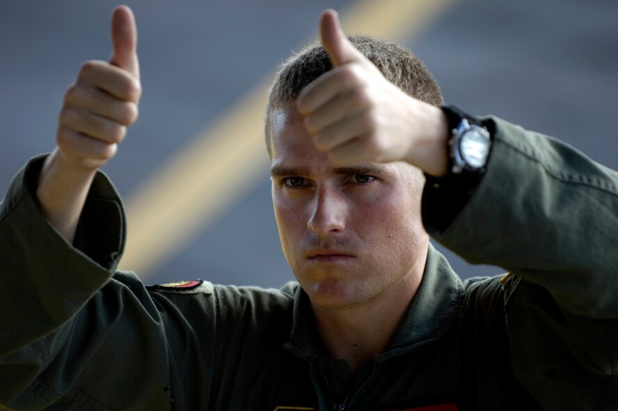 Airman First Class Daniel Baker directs a forklift to the back of his C-17 Globemaster III at Wake Island Sept. 12, 2006. The C-17 is taking members of the 36th Contingency Response Group, Andersen Air Force Base, Guam back home. The 36th CRG was the initial assessment team on the island to survey the airfield and determine if aircraft could land after the island was hit by Super Typhoon Ioke Aug 31. A1C Baker is a loadmaster from the 535th Airlift Squadron at Hickam Air Force Base, Hawaii. (U.S. Air Force photo/Tech. Sgt. Shane A. Cuomo)