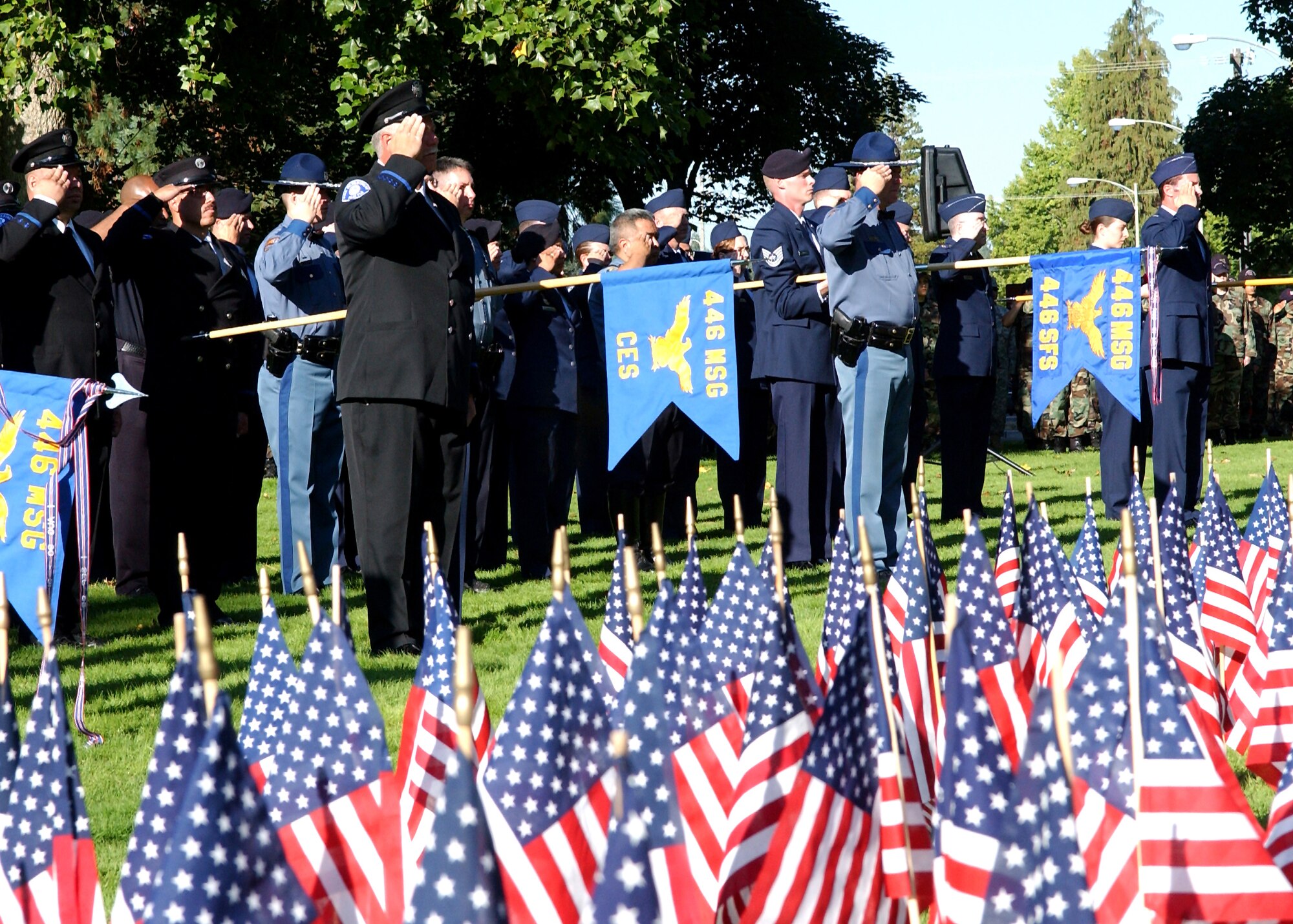 MCCHORD AIR FORCE BASE, Wash., - Reservists for the 446th Airlift Wing salute while in formation during a 9-11 Ceremony here.  The ceremony, hosted by the 446th Airlift Wing and Brig. Gen. Eric Crabtree, served to honor 9-11 first responders, such as firefighters, police, and paramedics. Reservists who work as first responders in their civilian careers wore those uniforms in formation to acknowledge that dual role.  Guests at the ceremony included Governor Chris Gregoire, as well as firefighters, police officers and paramedics from several communities surrounding McChord. (U.S. Air Force photo by Abner Guzman)                             