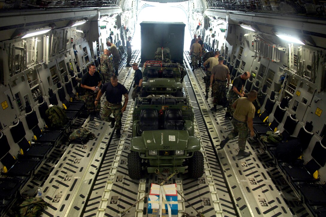 Airmen from the 36th Contingency Response Group load their gear and equipment onto a C-17 Globemaster III on Wake Island Sept. 12. The C-17, from the 535th Airlift Squadron at Hickam Air Force Base, Hawaii, is taking the 36th CRG back home to Andersen Air Force Base, Guam. The 36th CRG was the initial assessment team on the island to survey the airfield after the island was hit by Super Typhoon Ioke Aug. 31. (U.S. Air Force photo/Tech. Sgt. Shane A. Cuomo)