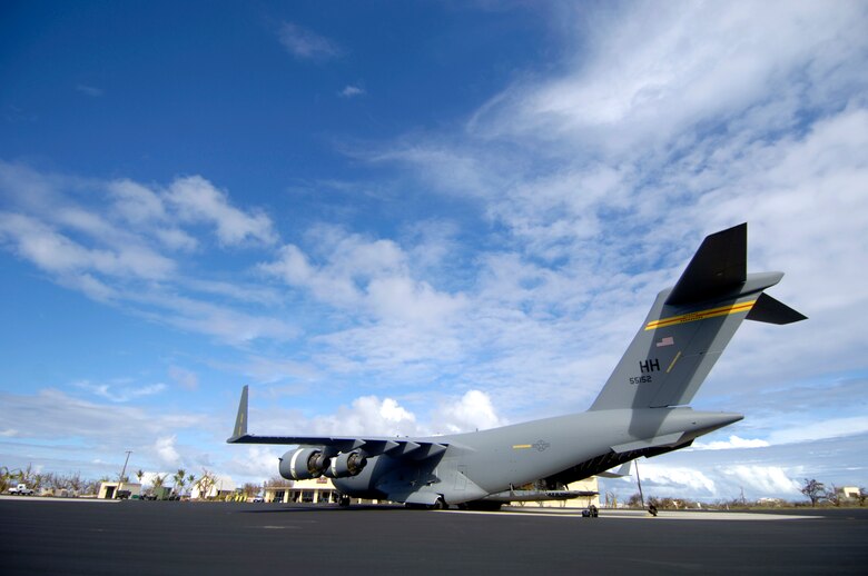 A C-17 Globemaster III sits in front of the airfield operations building on Wake Island Sept. 12. The C-17, from the 535th Airlift Squadron at Hickam Air Force Base, Hawaii, flew a 53-person team to the island to assess damage left by Super Typhoon Ioke after it hit the island Aug. 31. (U.S. Air Force photo/Tech. Sgt. Shane A. Cuomo) 

