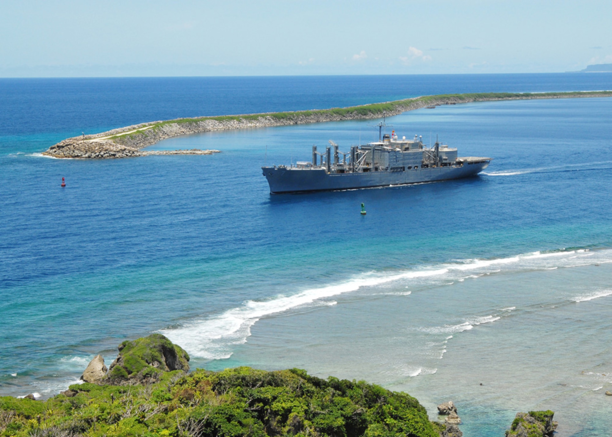 The USNS San Jose sails out of Guam's Apra Harbor Sept. 4 to begin its 1,500-mile journey to Wake Island. Onboard the San Jose were members of the 36th Contingency Response Group and the Navy Helicopter Sea Combat Squadron 25, both of Andersen Air Force Base, Guam, to make the initial assessment of damage left by Super Typhoon Ioke. (U.S. Navy photo/Petty Officer 2nd Class John F. Looney)