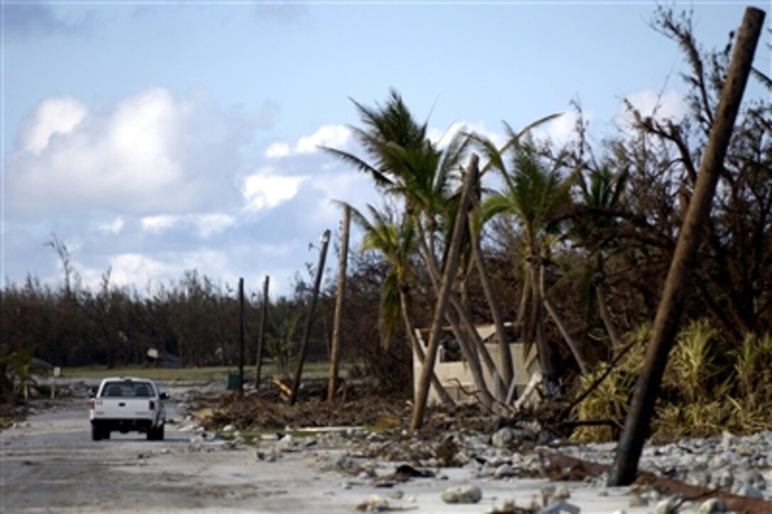 A truck drives past the devastation left by Super Typhoon Ioke on Wake Island, Sept. 12, 2006. A C-17, from the 535th Airlift Squadron, Hickam Air Force Base, Hawaii, flew a 53-person team comprised of personnel from 15th Civil Engineering Squadron and Department of Defense employees and contractors to assess damage left by the typhoon that struck the island, Aug. 31, 2006. 