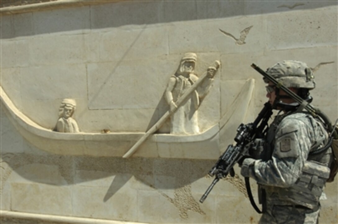 U.S. Army Spc. Anthony D. Johnston patrols by a caved marble wall as his company conducts a reconnaissance mission in Sadr City, Iraq, on Sept. 8, 2006.  Johnston is assigned to Charlie Company, 1st Battalion, 17th Infantry Regiment, 172nd Stryker Brigade Combat Team.  