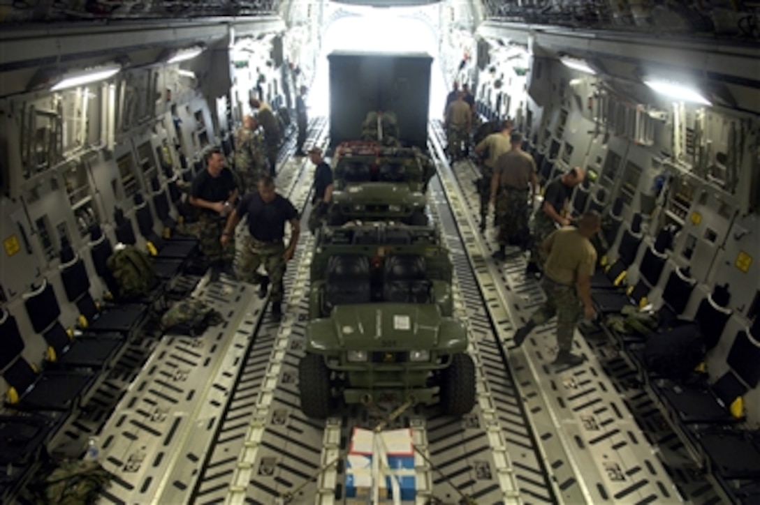 U.S. Air Force personnel with the 36th Contingency Response Group load their gear onto a C-17 Globemaster III aircraft on Wake Island on Sept. 12, 2006.  The 36th Response Group was the initial assessment team on the island to survey the airfield to determine if aircraft could land after the island was hit by Super Typhoon Ioke on Aug. 31, 2006.  