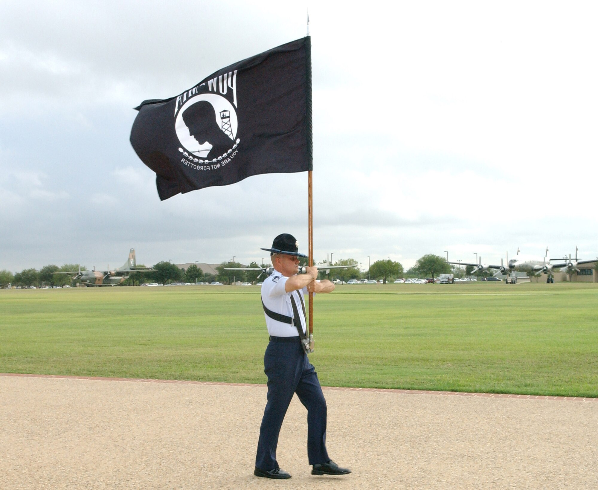 Master Sgt. Rodney Simington carries the POW/MIA flag during the basic military training graduation ceremony Sept. 15 at Lackland Air Force Base, Texas.  The parade recognized POW/MIA Day where several former POWs joined the members of the 37th Training Wing as reviewing officials for the parade.  Sergeant Simington is with the 323rd Training Squadron.  (U.S. Air Force photo/Alan Boedeker) 