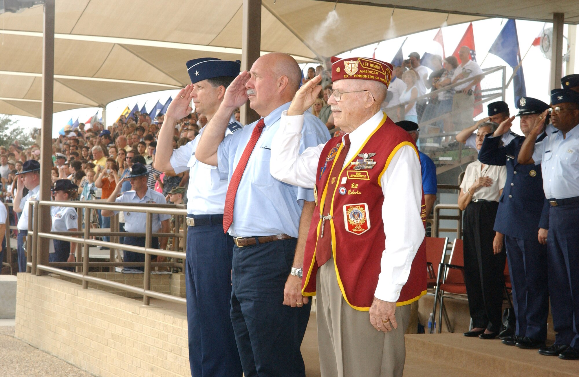 Two former POWs joined the training wing commander as reviewing officials during the basic military training graduation ceremony Sept. 15 at Lackland Air Force Base, Texas.  Standing with Brig. Gen. Darrell D. Jones, 37th Training Wing commander, are retired Col. Joseph Milligan and retired Maj. Bill Roberts.  Colonel Milligan was shot down May 20, 1967, while flying his 113th combat mission in an F-4 Phantom over North Vietnam.  Major Roberts was flying in a B-17 Flying Fortress during World War II when he was shot down over Czechoslovakia.  (U.S. Air Force photo/Robbin Cresswell)