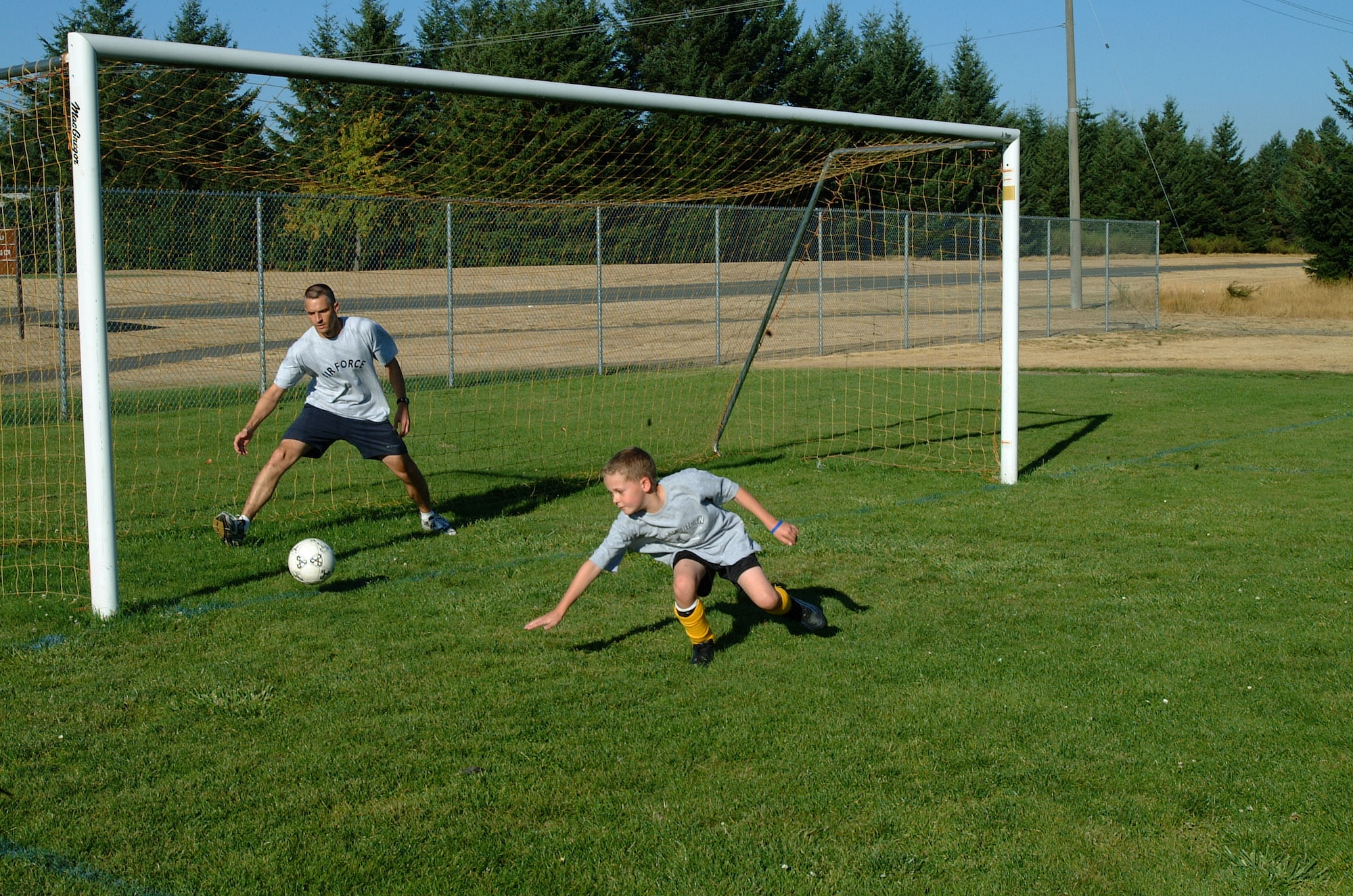 MCCHORD AIR FORCE BASE, Wash. -- Lt. Col. Ted Detwiler, 62nd Operations Support Squadron, coaches 9-year-old Jeremy Poppert in the finer points of playing goalie.
(U.S. Air Force photo by Tyler Hemstreet)
