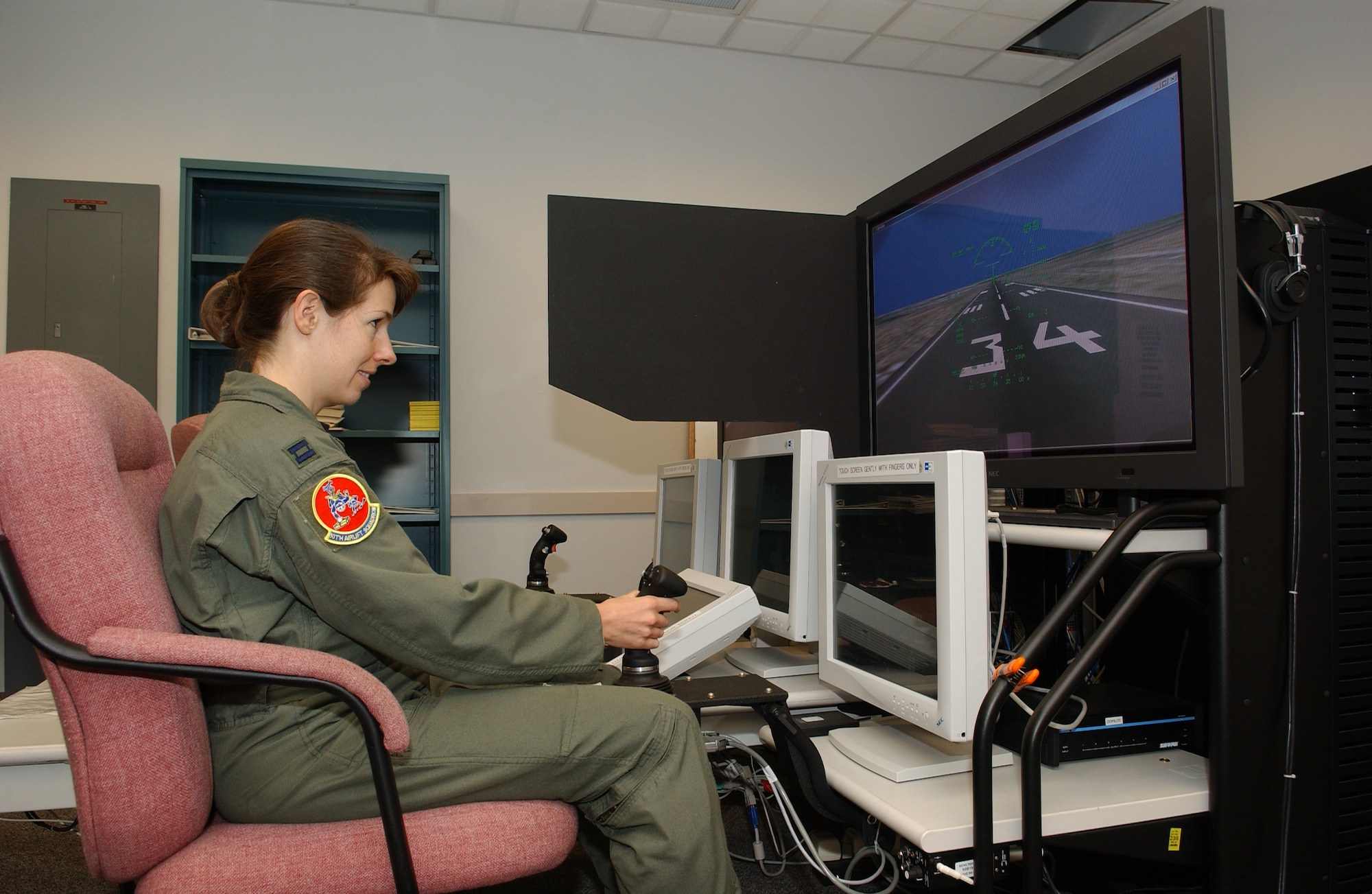 MCCHORD AIR FORCE BASE, Wash. --
Capt. Anne Lueck, 10th Airlift Squadron, sits at the controls of a desktop simulator used to help pilots familiarize themselves with the controls of a C-17 Globemaster III.
(U.S. Air Force photo by Abner Guzman)

