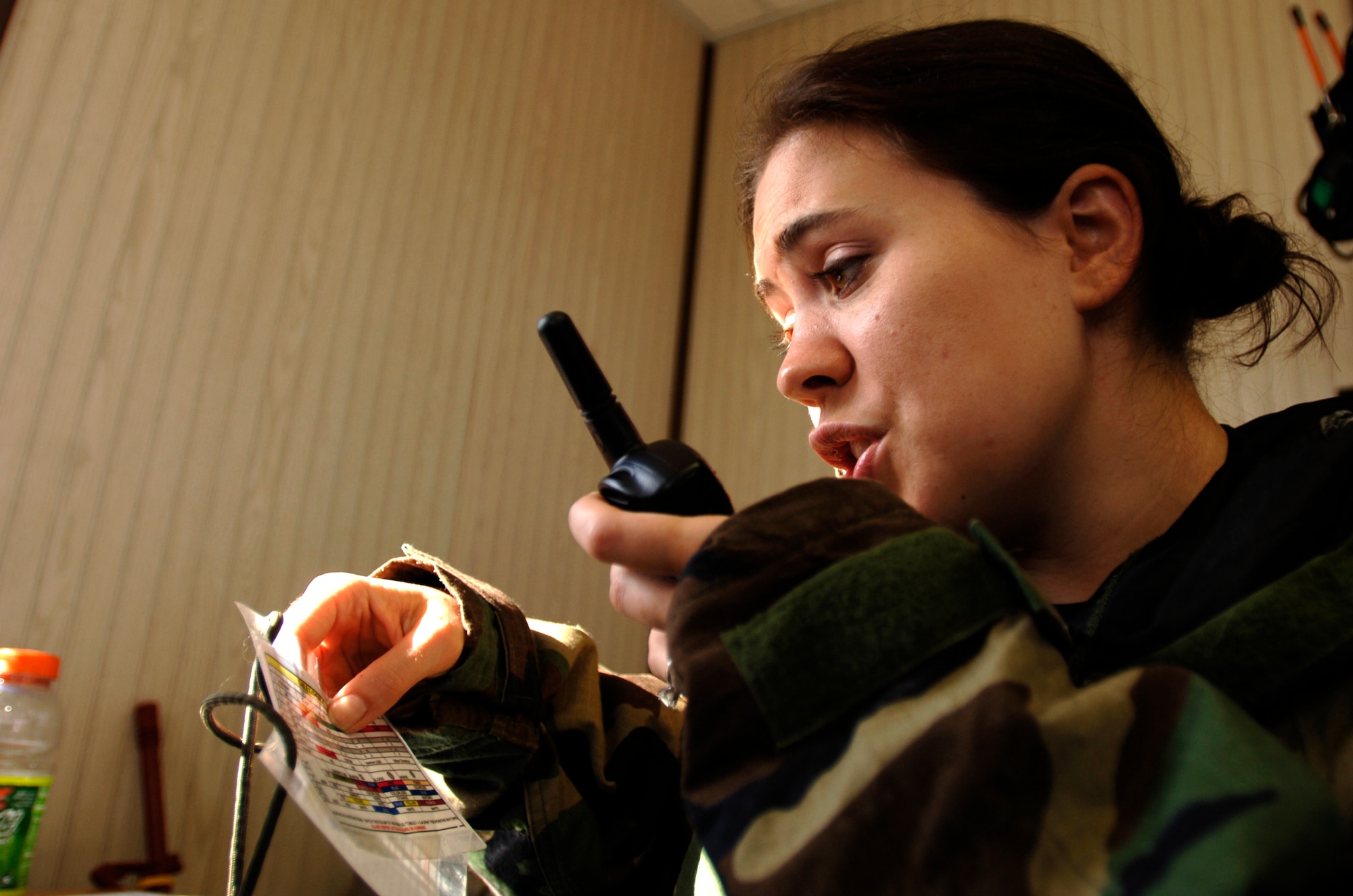 Capt. Kourtney Shaw receives in-the-field information from her team participating in the Chemical Biological Radiological Nuclear Challenge at Brooks City-Base, San Antonio, Sept. 15. Captain Shaw is assigned to Shaw Air Force Base, S.C. (U.S. Air Force photo/Tech. Sgt. Cecilio M. Ricardo Jr.)
