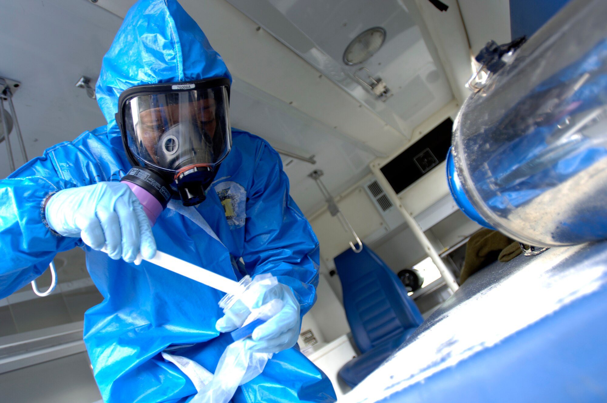 Staff Sgt. Jared Thomas collects samples of spilled powder at a simulated ambulance crash scenario at the Chemical Biological Radiological Nuclear Challenge at Brooks City-Base, San Antonio, Sept. 15. Sergeant Thomas is a participant from Air Mobility Command. (U.S. Air Force photo/Tech. Sgt. Cecilio M. Ricardo Jr.)

