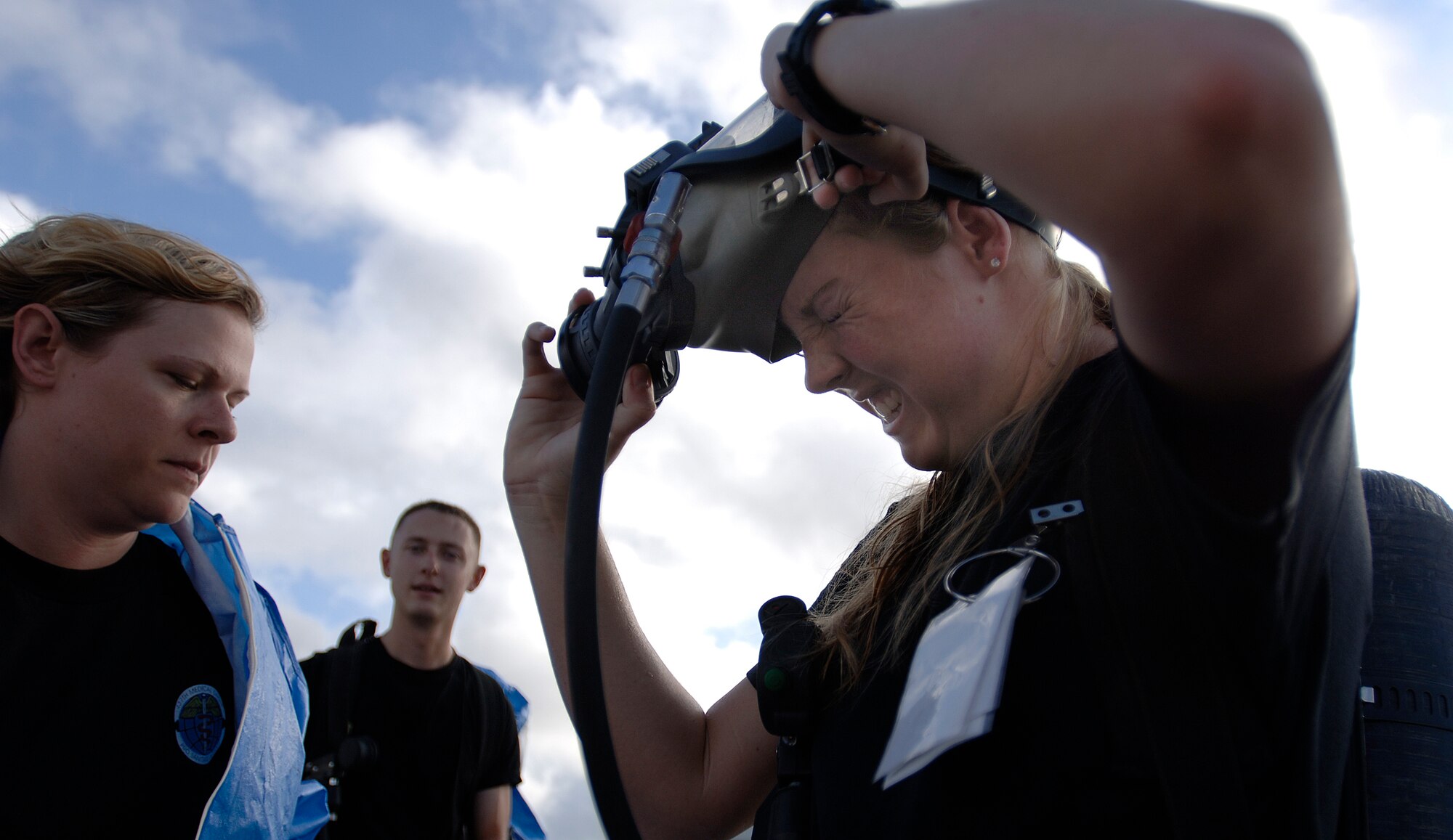 Senior Airman Rebecca Carey removes her gas mask after inspecting a simulated ambulance crash scenario at the Chemical Biological Radiological Nuclear Challenge at Brooks City-Base, San Antonio, Sept. 15. Airman Carrey is a participant from Air Mobility Command. (U.S. Air Force photo/Tech. Sgt. Cecilio M. Ricardo Jr.)
