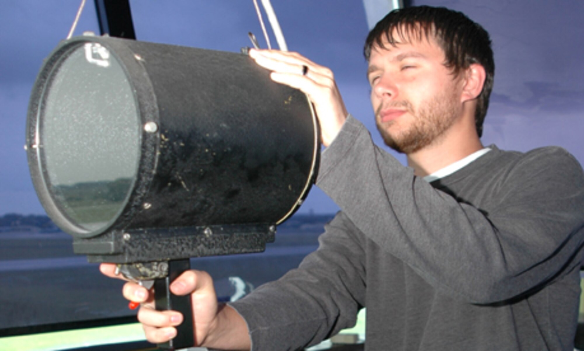GRISSOM AIR RESERVE BASE, Ind -- Jason Tresse, an air traffic controller at Grissom Air Reserve Base demonstrates how a control tower light gun is used to communicate with aircraft and vehicles on the runway when radio contact is not available.  Mr. Tresse served six years of active duty in the Air Force before coming to Grissom. (U.S. Air Force photo/SrA. Ben Mota)