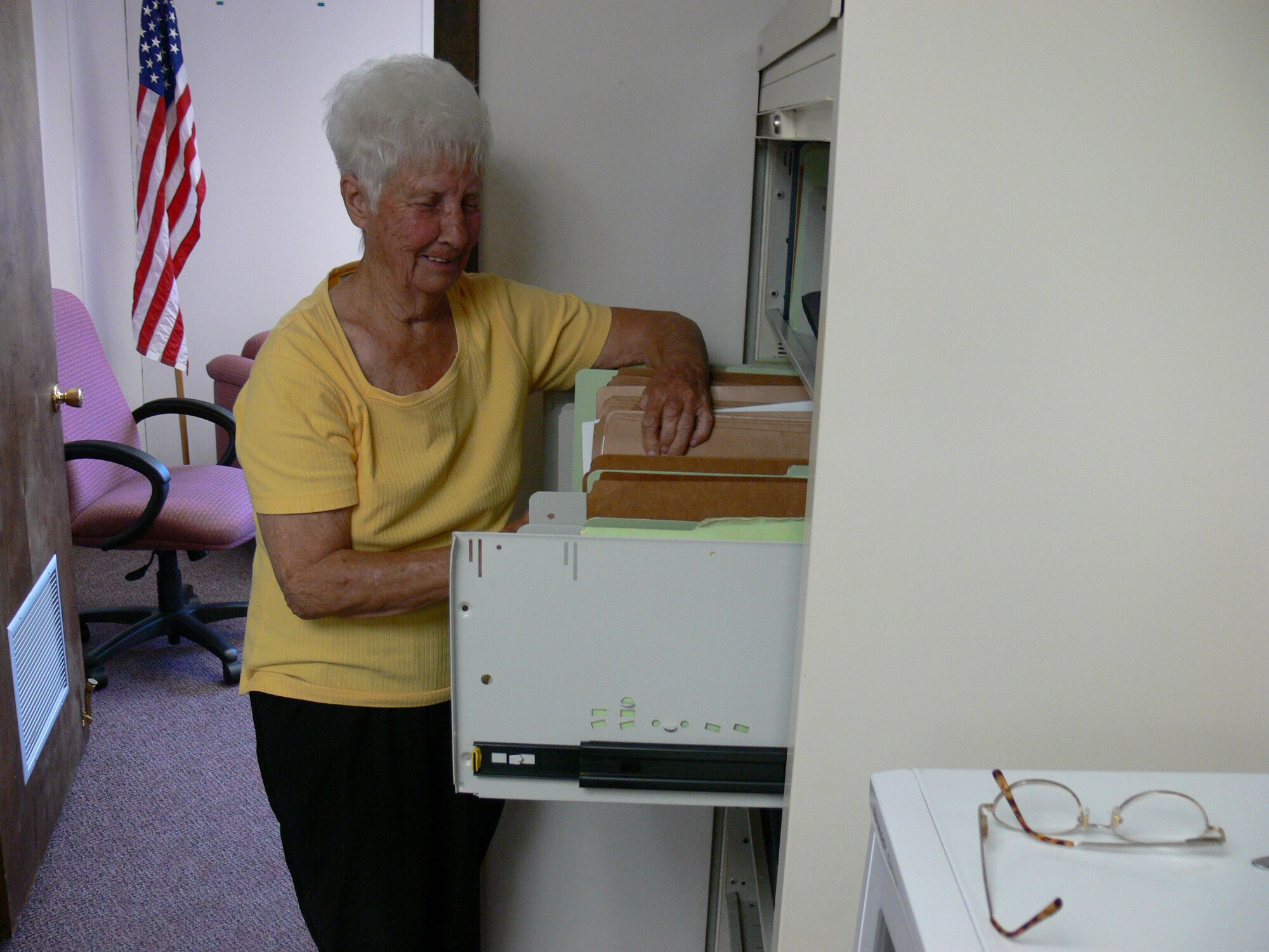 Myrtice Miller, 347th Communication Squadron publications and forms manager, searches for a file in her office recently. Ms. Miller has worked at Moody for 50 years and held a wide variety of positions. (Photo by Airman 1st Class Eric Schloeffel)