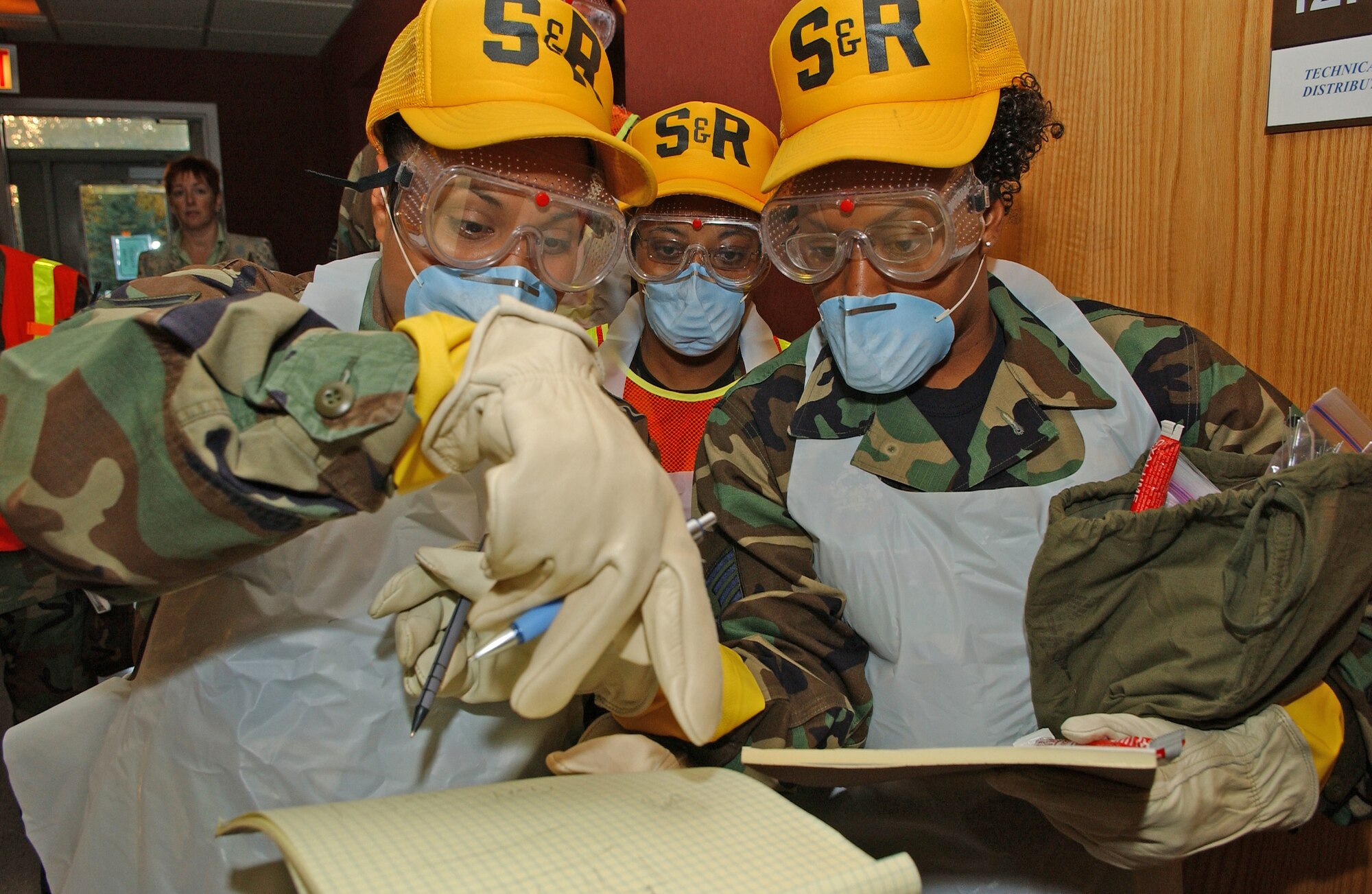 Staff Sgt. Susannah Lutchman-Hertel (left) and Staff Sgt. Talisa Arnold plot and record body parts during the Arctic Gold 06-08 Emergency Mangement Exercise during the 354th Fighter Wing's Unit Compliance Inspection on Sept. 11, 2006. Both Staff Sergeant's are assigned to the 354th Services Squadron, 354th Mission Support Group, 354th Fighter Wing, Eielson Air Force Base, Alaska. (USAF Photo by Senior Airman Anthony Nelson Jr)