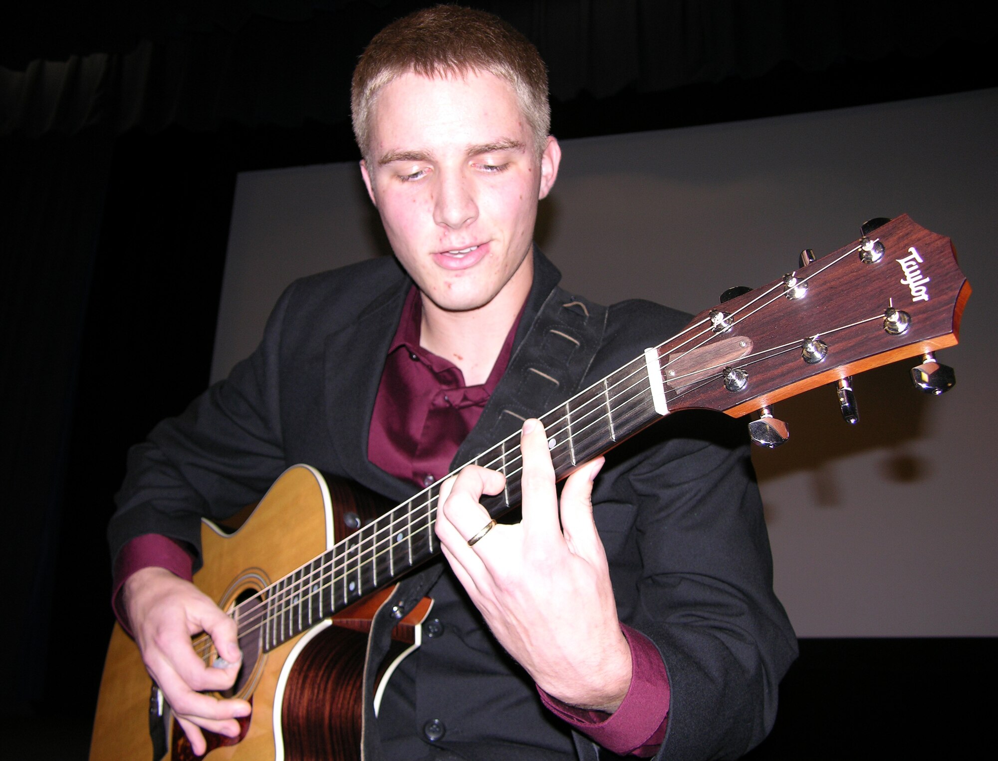 Airman 1st Class Elliott Brown, 16th Component Maintenance Squadron, sings and plays his guitar Sept. 7 during his Tops in Blue audition at the base theater.


