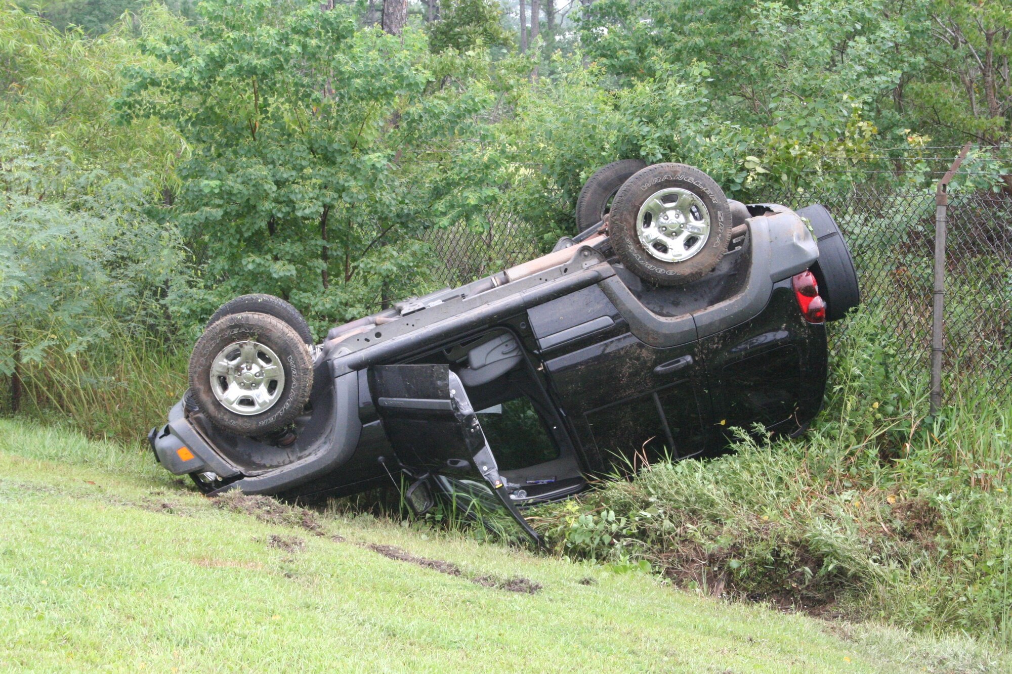 Another vehicle rolled over at the East Gate Sept. 7 due to a rain-slicked road and increased speed in a curve. This was the third rollover in the past two months. Drivers are asked to exercise caution when departing the East gate, especially on rainy days. (U.S. Air Force Photograph by Staff Sgt. Mareshah Haynes)

