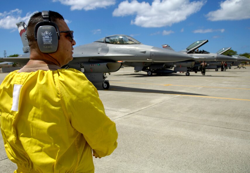 Tech. Sgt. Gerardo Guevara waits for his F-16 Fighting Falcons to shut down their engines before conducting his post flight checks at Hickam Air Force Base, Hawaii Sept. 8, 2006. Six F-16s from the Texas Air National Guard 149th Fighter Wing came to Hickam to participate in Exercise Sentry Aloha. The exercise brings dissimilar combat assets to Hickam to train with the Hawaii Air National Guard’s 199th Fighter Squadron. (U.S. Air Force photo/ Tech. Sgt. Shane A. Cuomo)