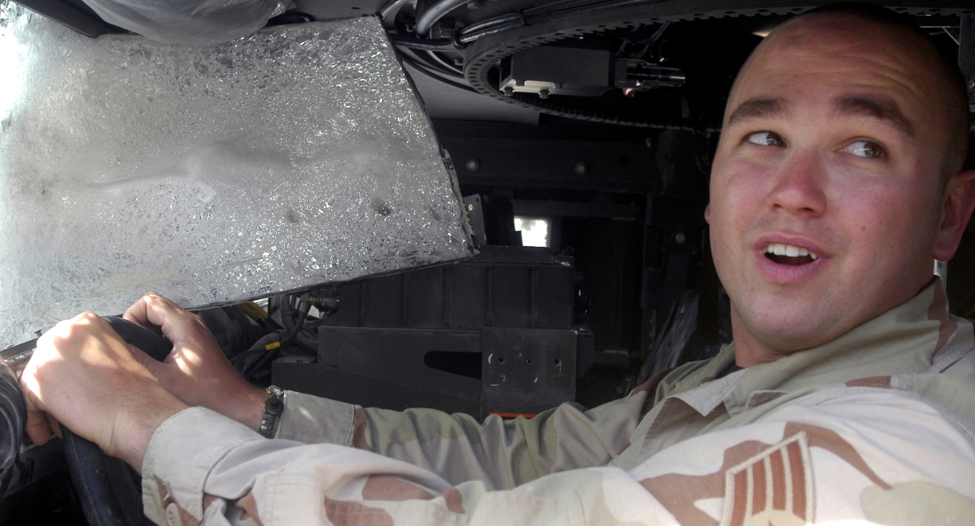 Staff Sgt. Mike Myers sits in the driver's seat of a Humvee he was operating when it was hit by a rocket-propelled grenade. The attack came Sept. 6 at almost the same time his son was being born in the United States. Sergeant Myers is a security forces member deployed to the Bagram Provincial Reconstruction Team from Goodfellow Air Force Base, Texas. (U.S. Air Force photo/Maj. David Kurle)
