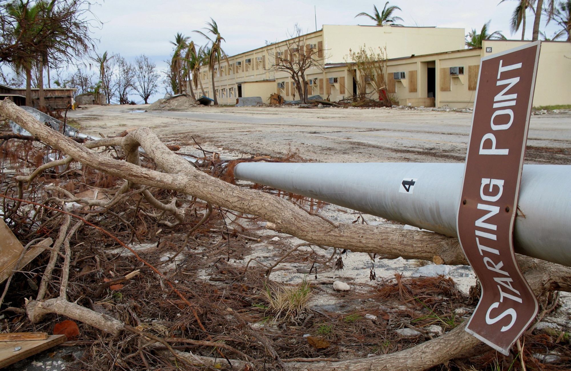 Debris and wreckage line the streets of the "downtown" area of Wake Island on Sept 14, 2006. Super Typhoon Ioke swept through on Aug 31 with wind speeds of 155 mph and gusts at 190 mph. A team of civil engineers and COMM experts deployed to the atoll from Hickam Air Force Base, Hawaii, to estimate the extent of the damage left by the category 5 storm. (U.S. Air Force photo / Tech. Sgt. Chris Vadnais)