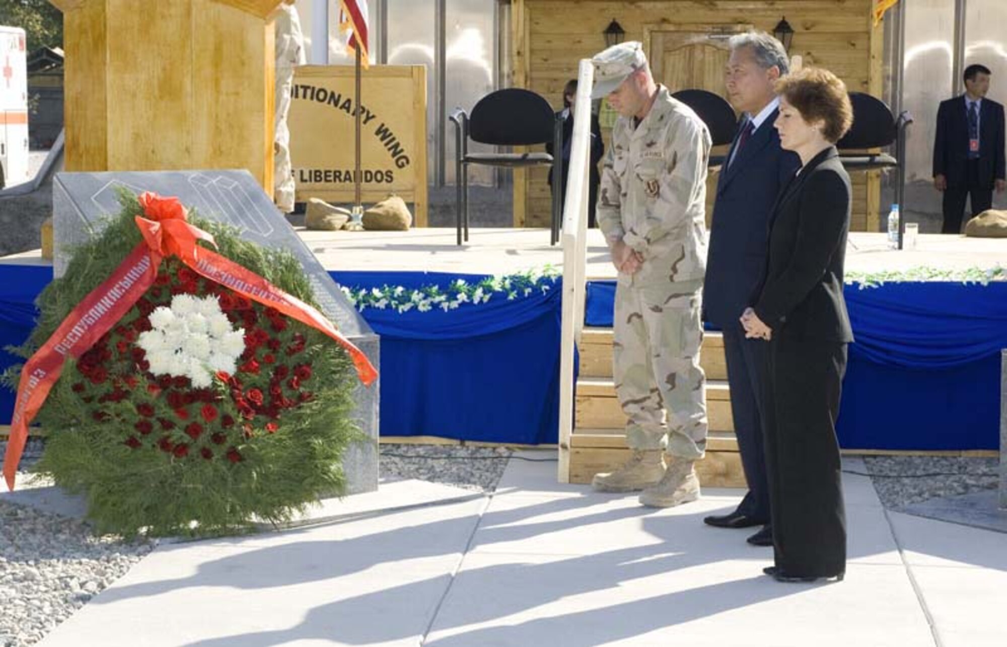 Col. Joel Reese, 376th Air Expeditionary Wing commander; Kurmanbek Bakiev, the president of Kyrgyzstan; and Marie Yovanovitch, U.S. Ambassador to the Kyrgyz Republic; pay tribute to the people who were killed during the terrorist attacks of 9/11. (U.S. Air Force photo/Jim Westfall)